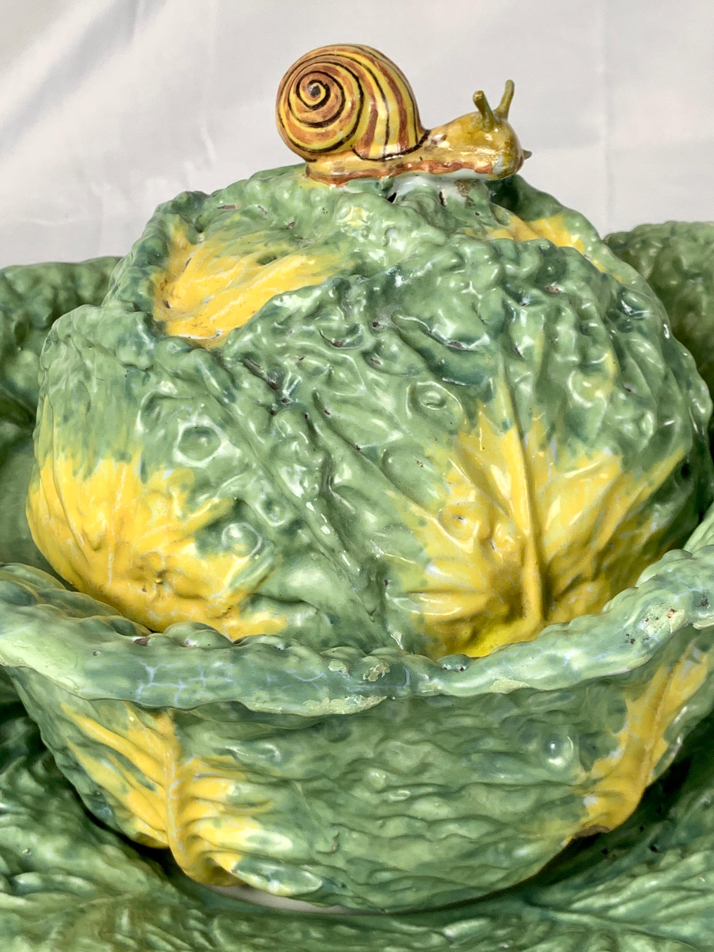 This faience soup tureen was made in the Philippe Mombaers factory in Brussels circa 1765. The cabbage tureen, its cover, and the stand are painted in green tones with yellow highlights. 
The color combination is exquisite!
The tureen is a gem of