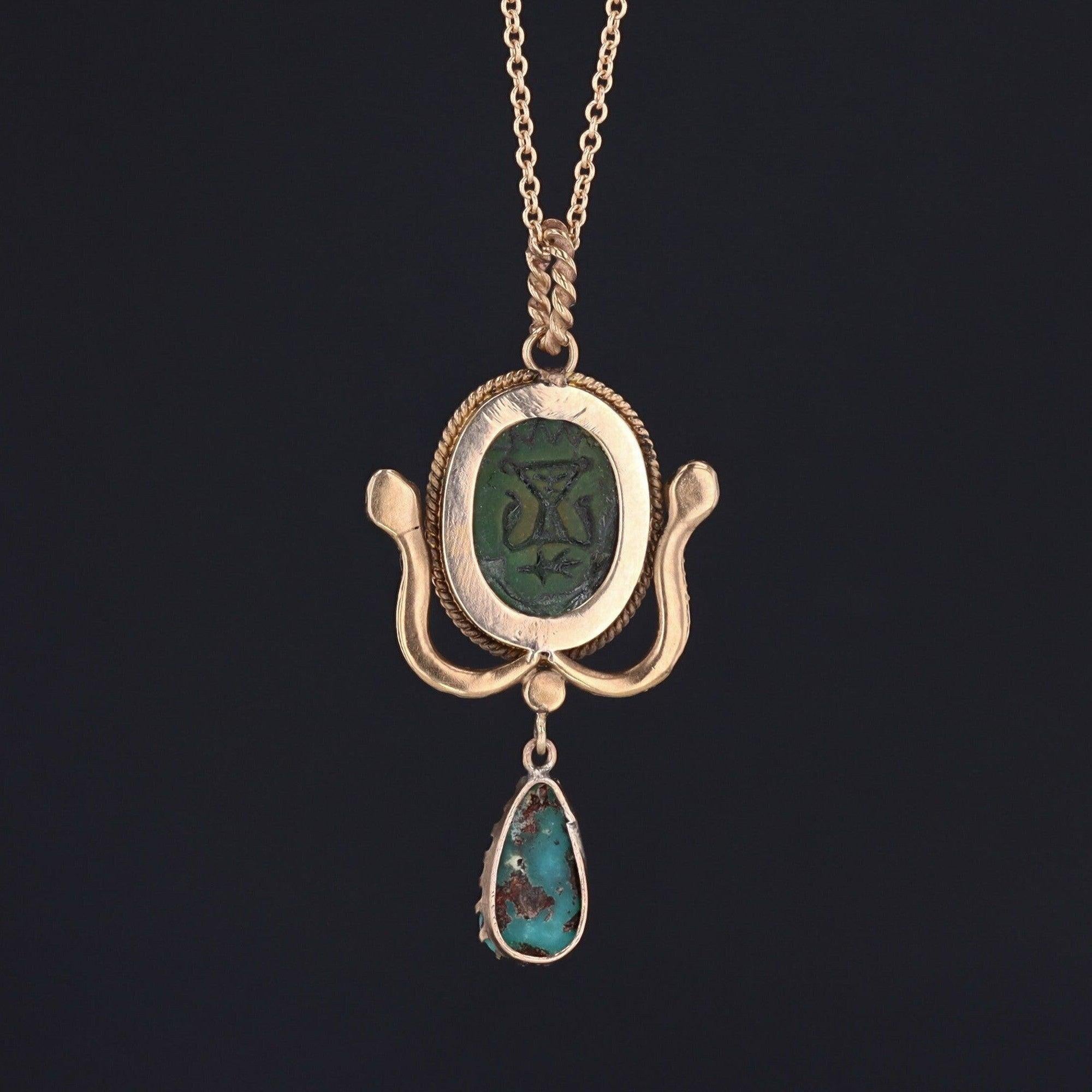 This enchanting pendant (circa 1900-1915) combines two powerful symbols of transformation and re-birth.

Snakes, which shed their skin, have long associations with transformation, immortality, and healing. Likewise, the scarab beetle, is also an