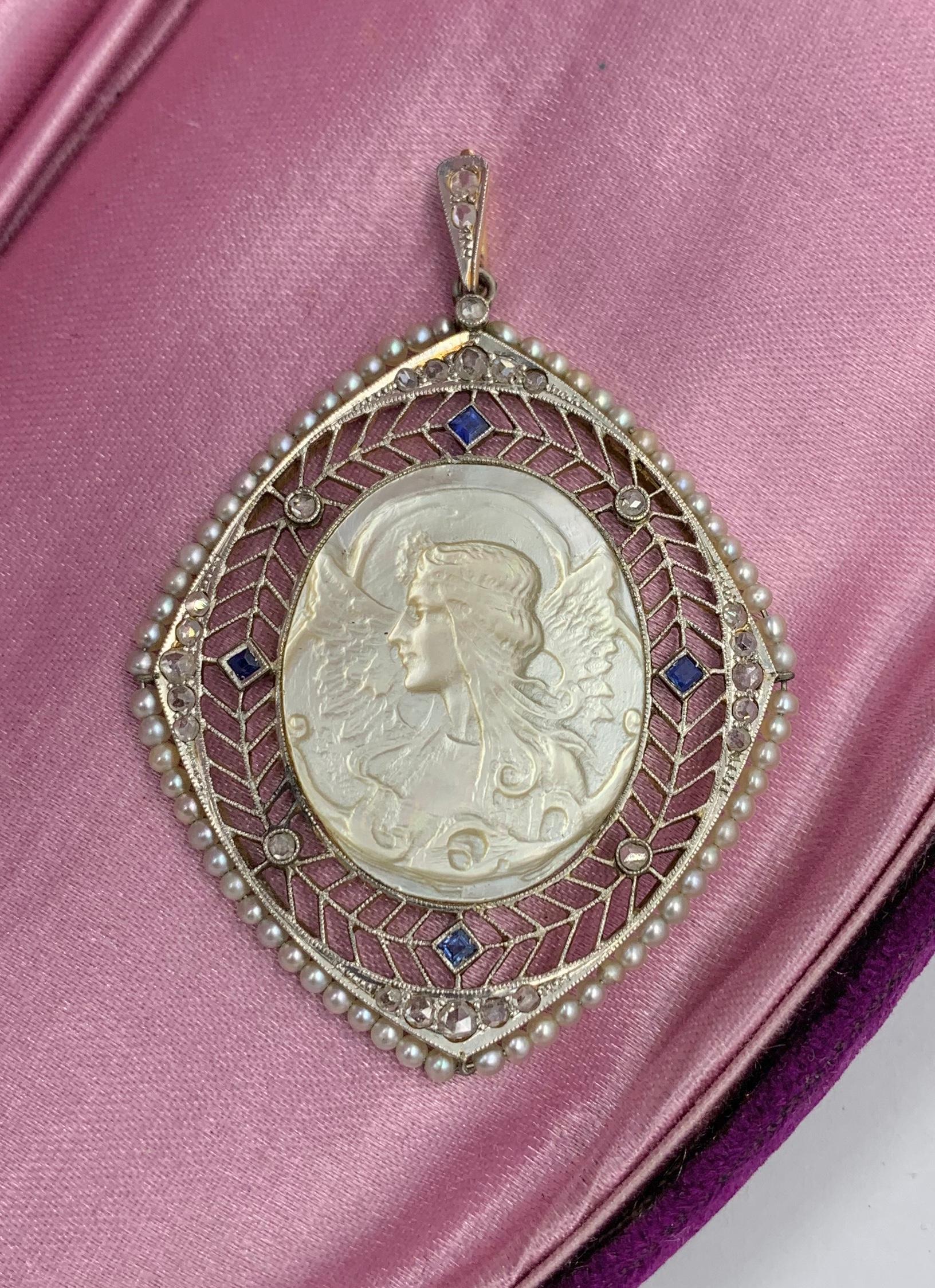 The extraordinary Sapphire, Rose Cut Diamond, Platinum Pendant with the image of a winged Fairy or Angel is a Museum Quality Jewel.  The Belle Epoque - Art Deco pendant is centered by the extraordinary carved Mother of Pearl medallion with an image