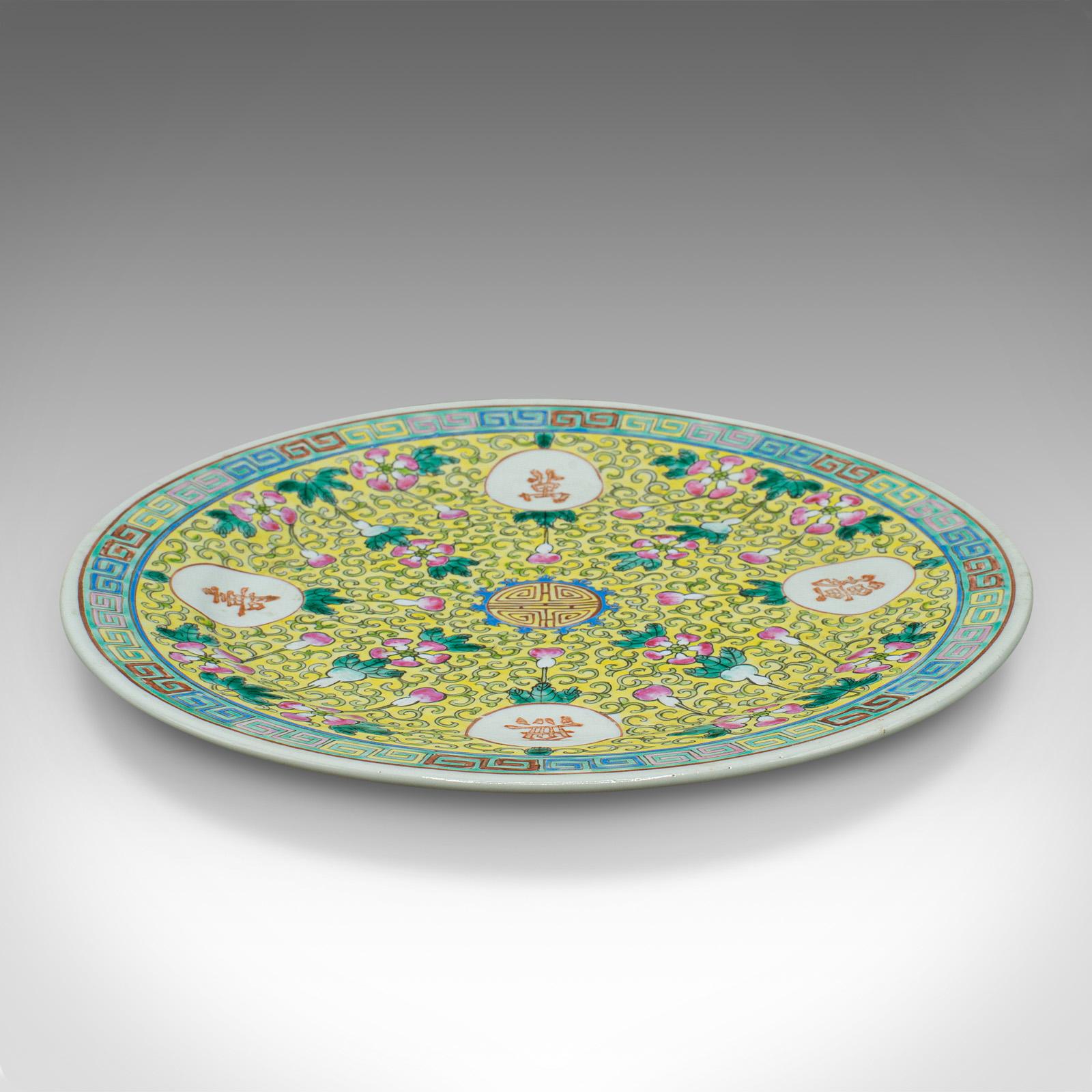 This is an antique Famille Jaune decorative plate. A Chinese, ceramic display dish, dating to the late Victorian period, circa 1900.

Charming example of the Famille Jaune taste
Displays a desirable aged patina and in good order
Vibrant yellow