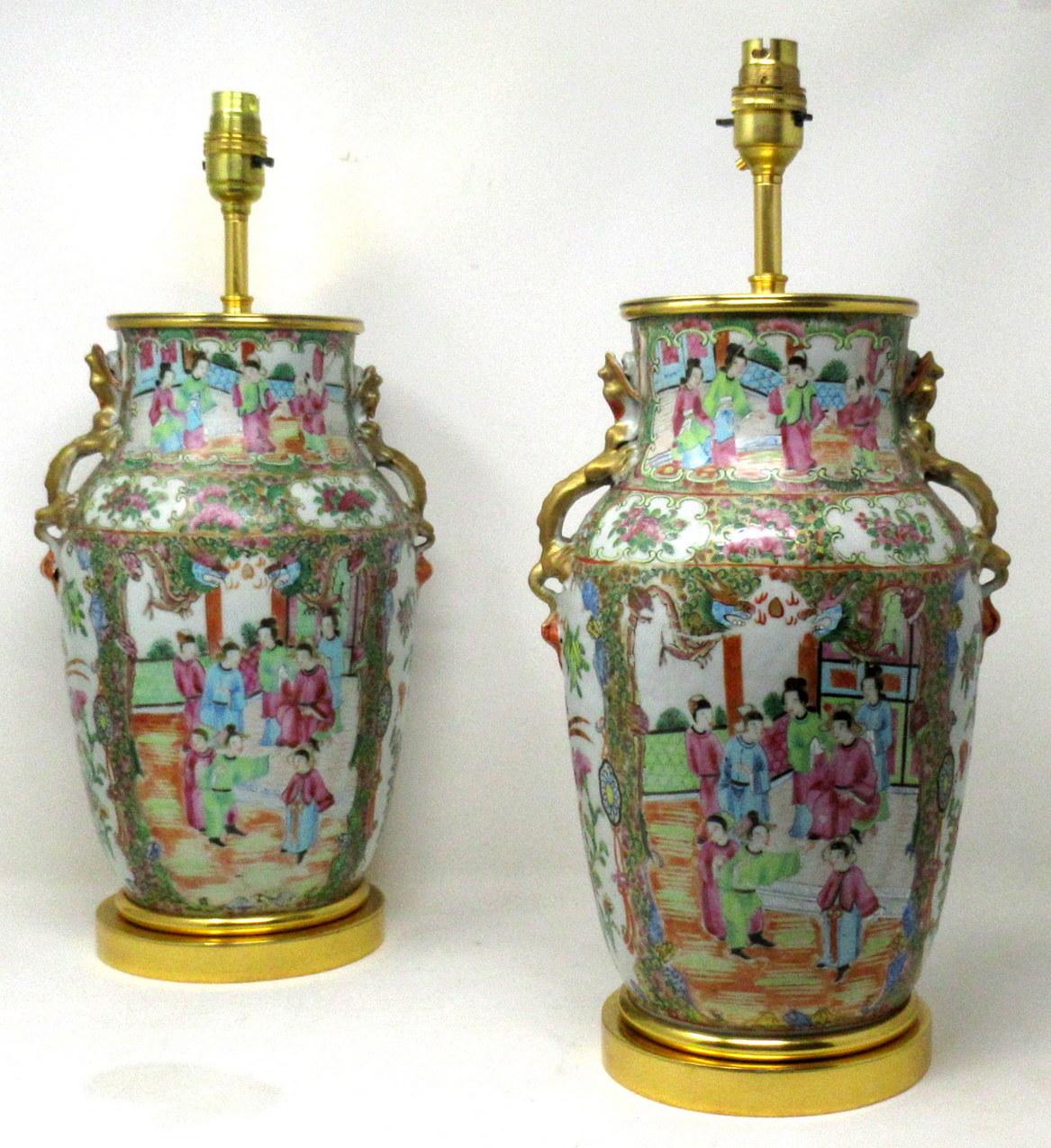 An Exceptionally Fine Pair of Chinese Cantonese Hand Decorated Porcelain Oil Lamps with ornate Ormolu bases now converted to Electric Table Lamps, of good size proportions, (see last image in situ) mid Nineteenth Century. 

The main outer bodies of