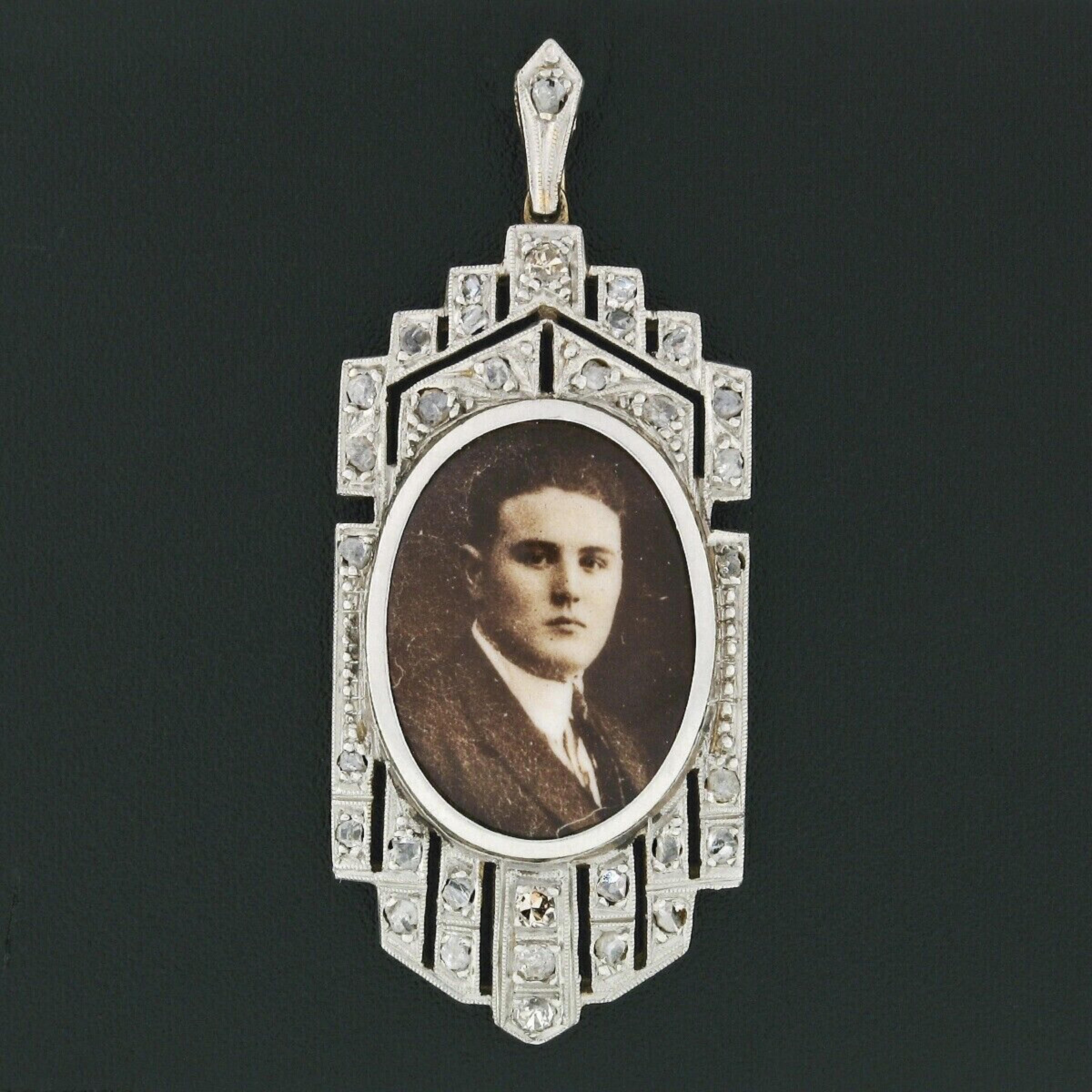 This very unusual antique pendant is crafted in solid 18k gold and platinum, featuring an old picture at its center, bezel framed and adorned with approximately 0.33 carats of rose cut diamonds throughout. The unique elongated shape is also adorned