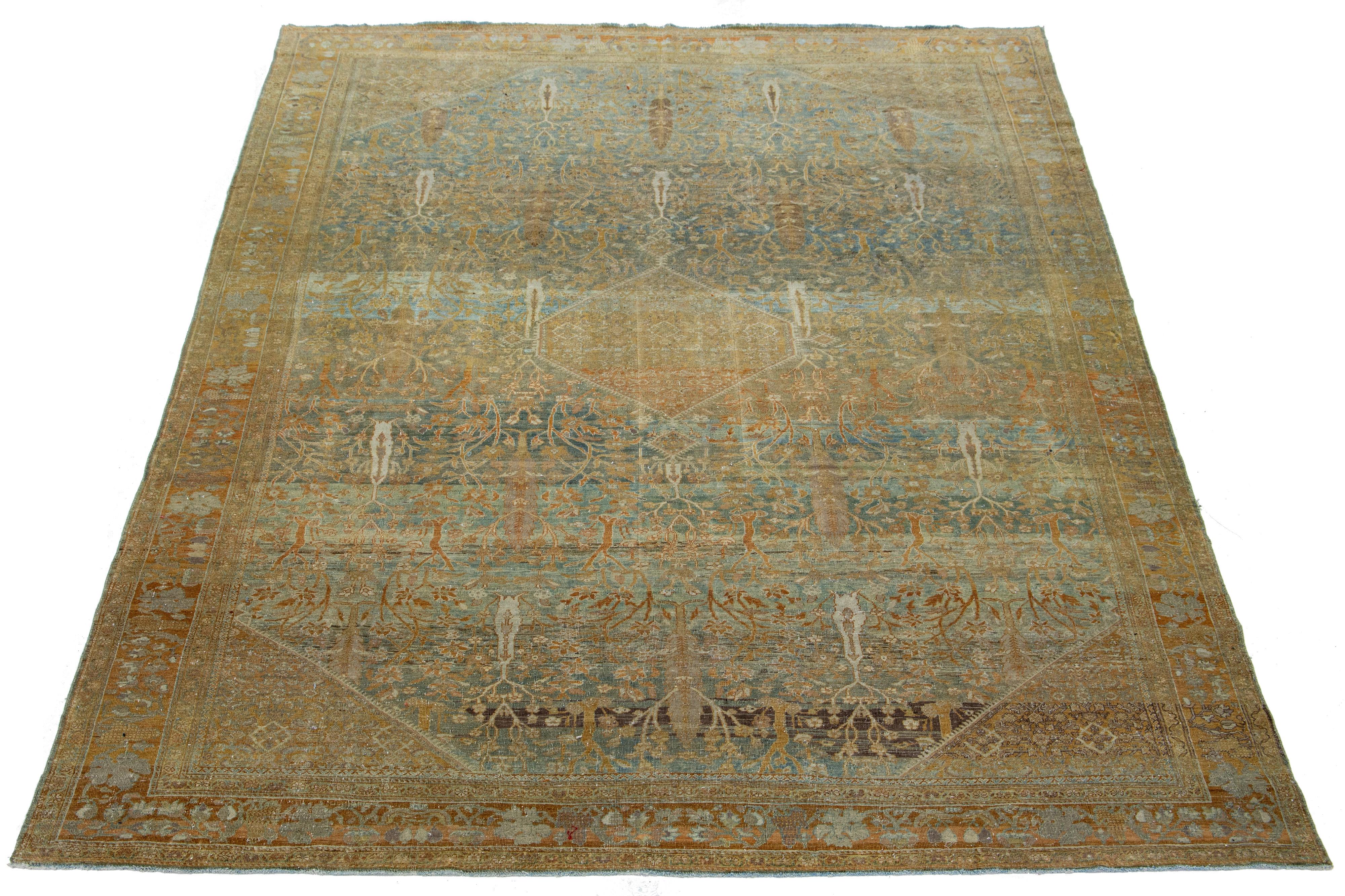 Beautiful Antique Sarouk hand-knotted wool rug with a blue color field. This Persian rug has a Classic beige, rust, and brown floral motif.

This rug measures 7'11
