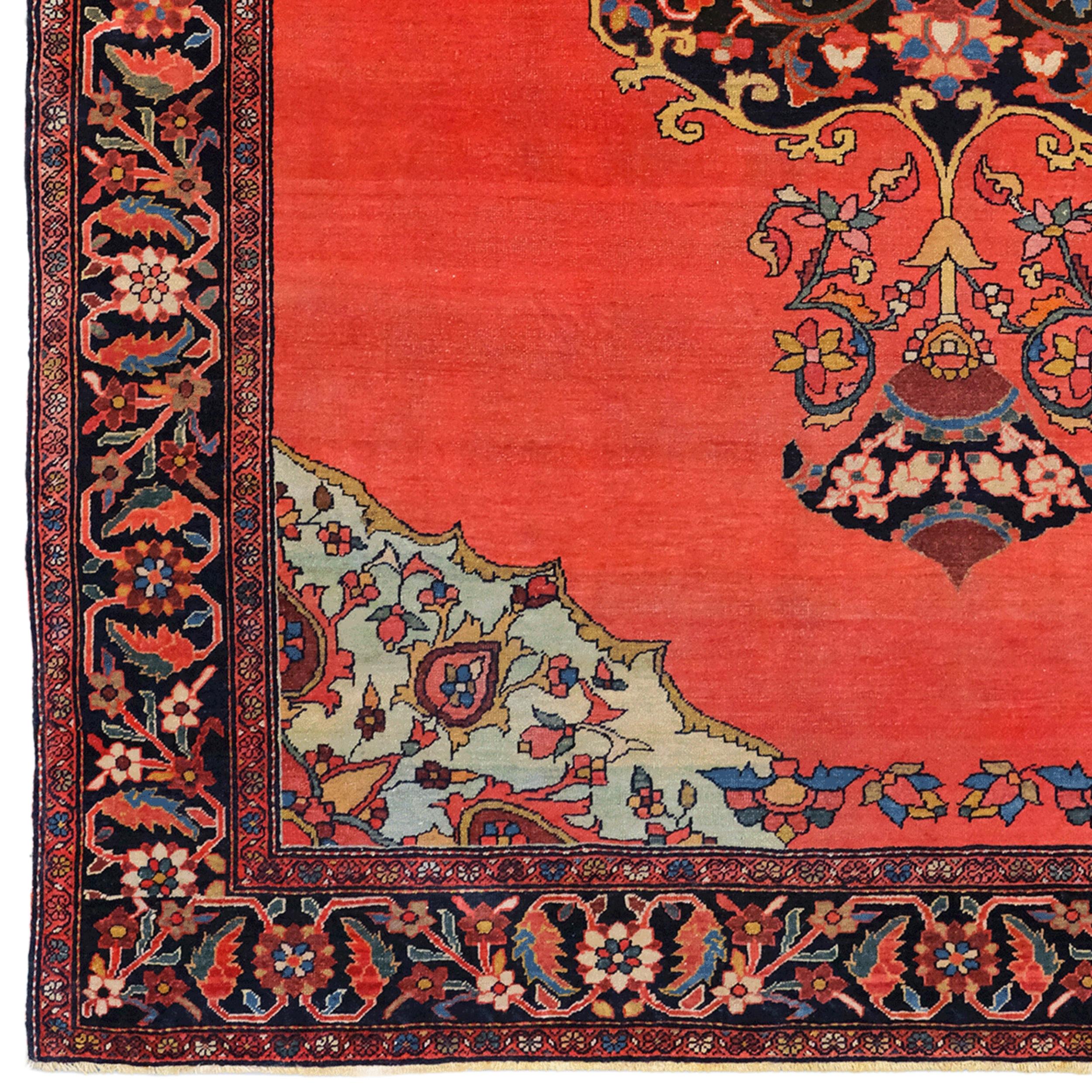 This 19th-century antique Farahan Sarouk rug stands out with its elegant patterns and vibrant colors. The center of the carpet is highlighted by a large medallion decorated with intricate floral motifs. This medallion placed on a red background is