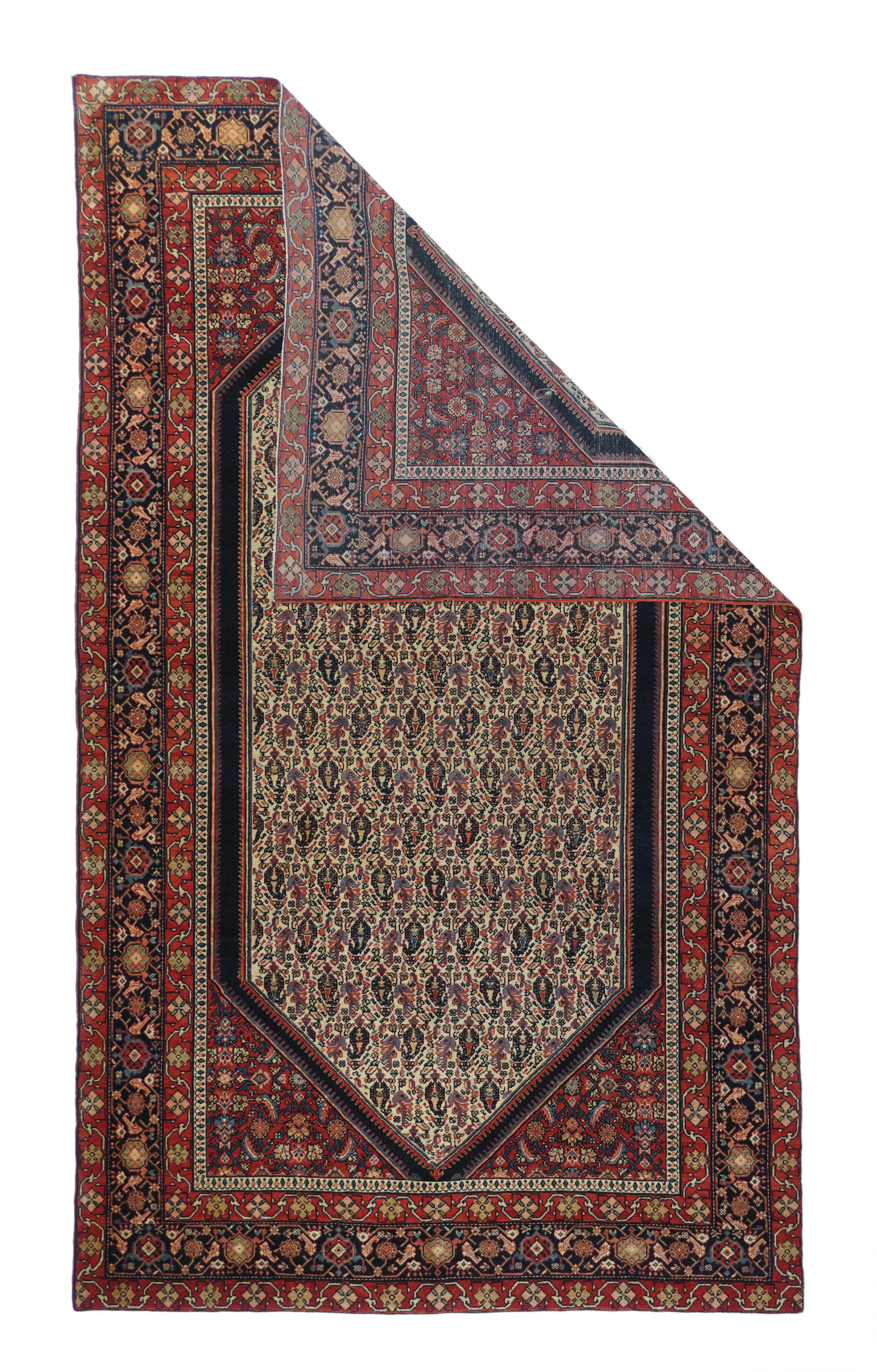 Antique Farahan Sarouk rug, measures: 3'10'' x 6'7''. The tall, hexagonal, sand field is densely covered with reversing rows of floriated botehs and associated leaves and bits of sten. A dark blue plain band surrounds the field and the red