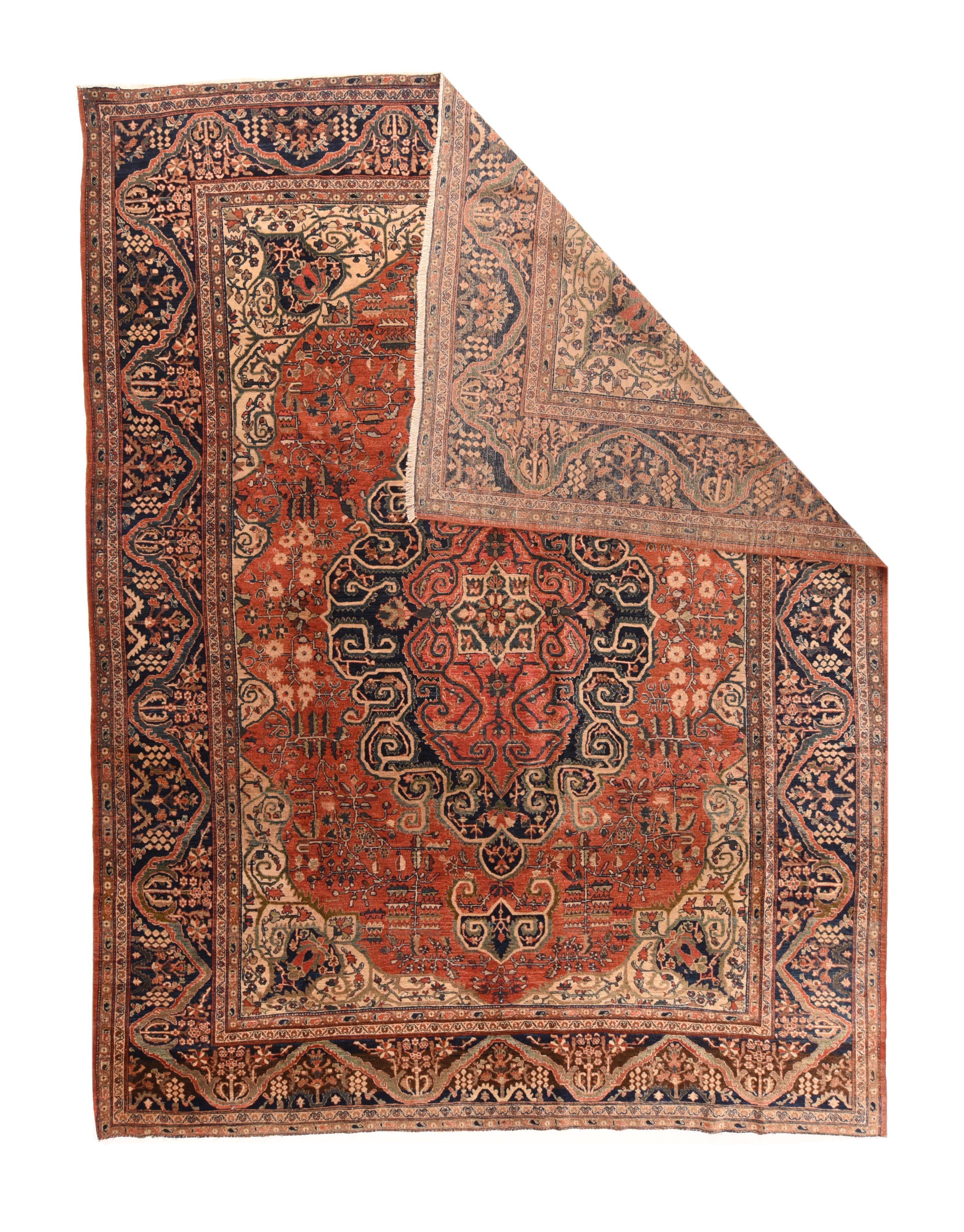 Antique Farahan Sarouk Rug 8'6'' x 11'. Classic palette with a rust madder field, navy indigo medallion and pendants with rigorous volute edging and ecru corners with angled navy vasiform elements and attendant angular volutes. Four flowers with