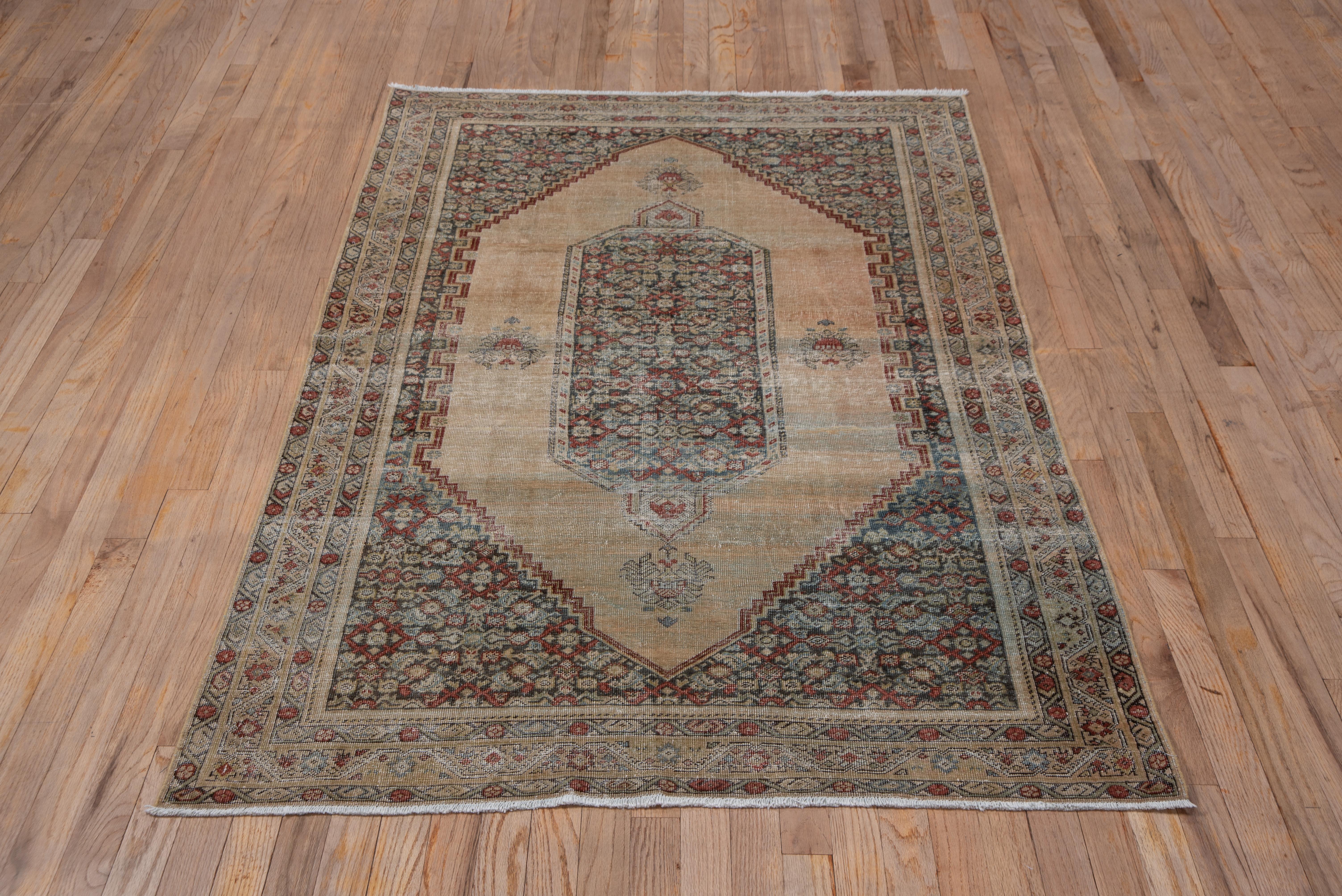 Just edging into the Farahan-Sarouk period, this west Persian village scatter has a fine weave, straw, notched sub field and brown small scale Herati corners. The central octagonal cartouche shows a slate ground Herati and pattern, and there are