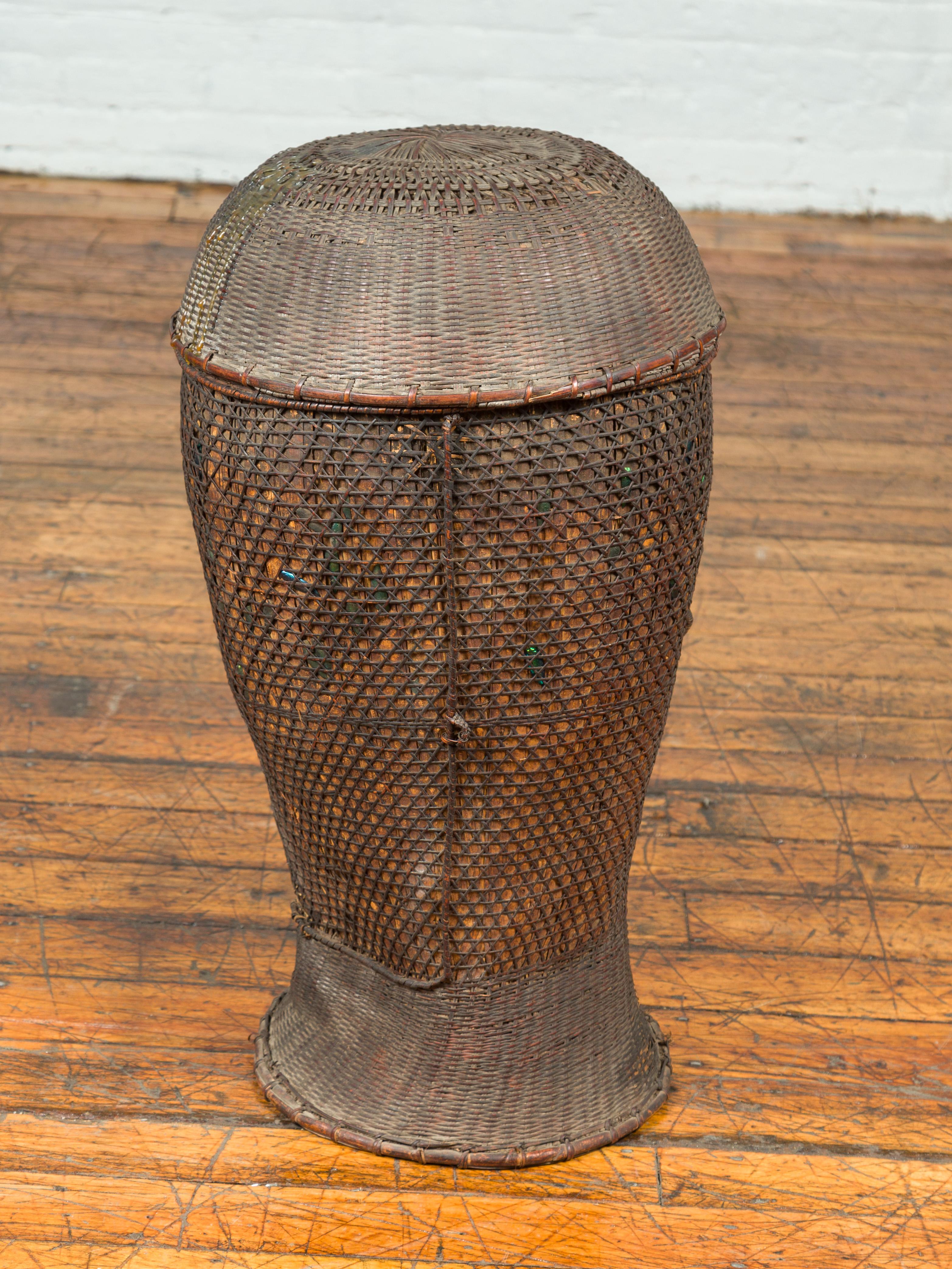 Rattan Antique Farmer's Grain Basket with Iridescent Motifs and Weathered Appearance For Sale
