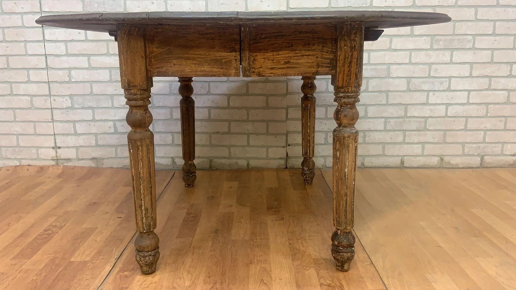 Antique Farmhouse Drop-Leaf Turned Leg Table

This antique farmhouse drop-leaf table boasts a classic design with turned legs and wooden bars enabling easy adjustment of its sides. The table showcases desired wear on the legs and apron, while the