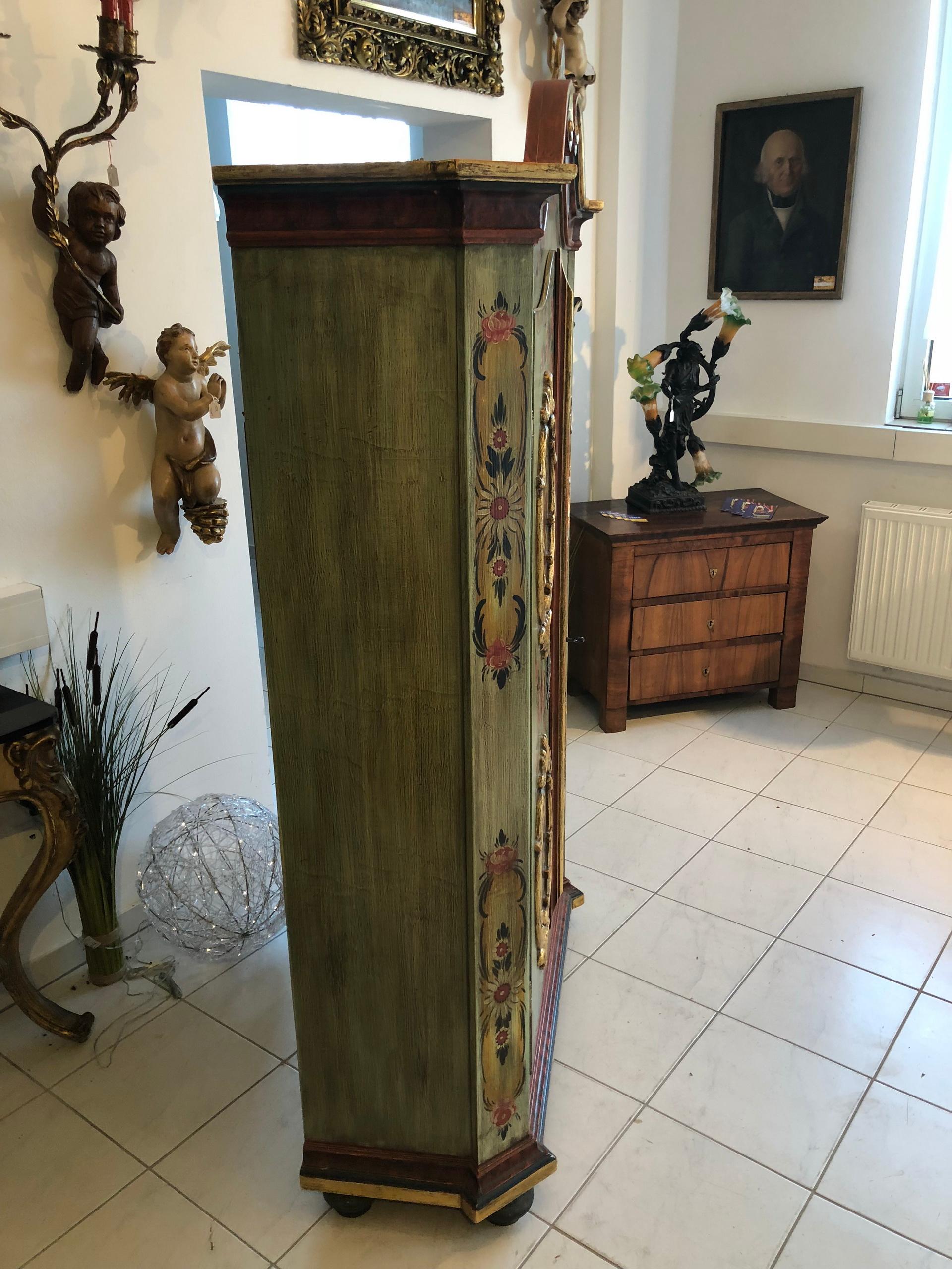 Original antique farmhouse Folk Art cabinet or wardrobe with a beautiful curved top and stunningly detailed hand painting.
The painting is a fine handmade work, circa 1970 on the original antique cabinet.
On the inside you will find shelves and a