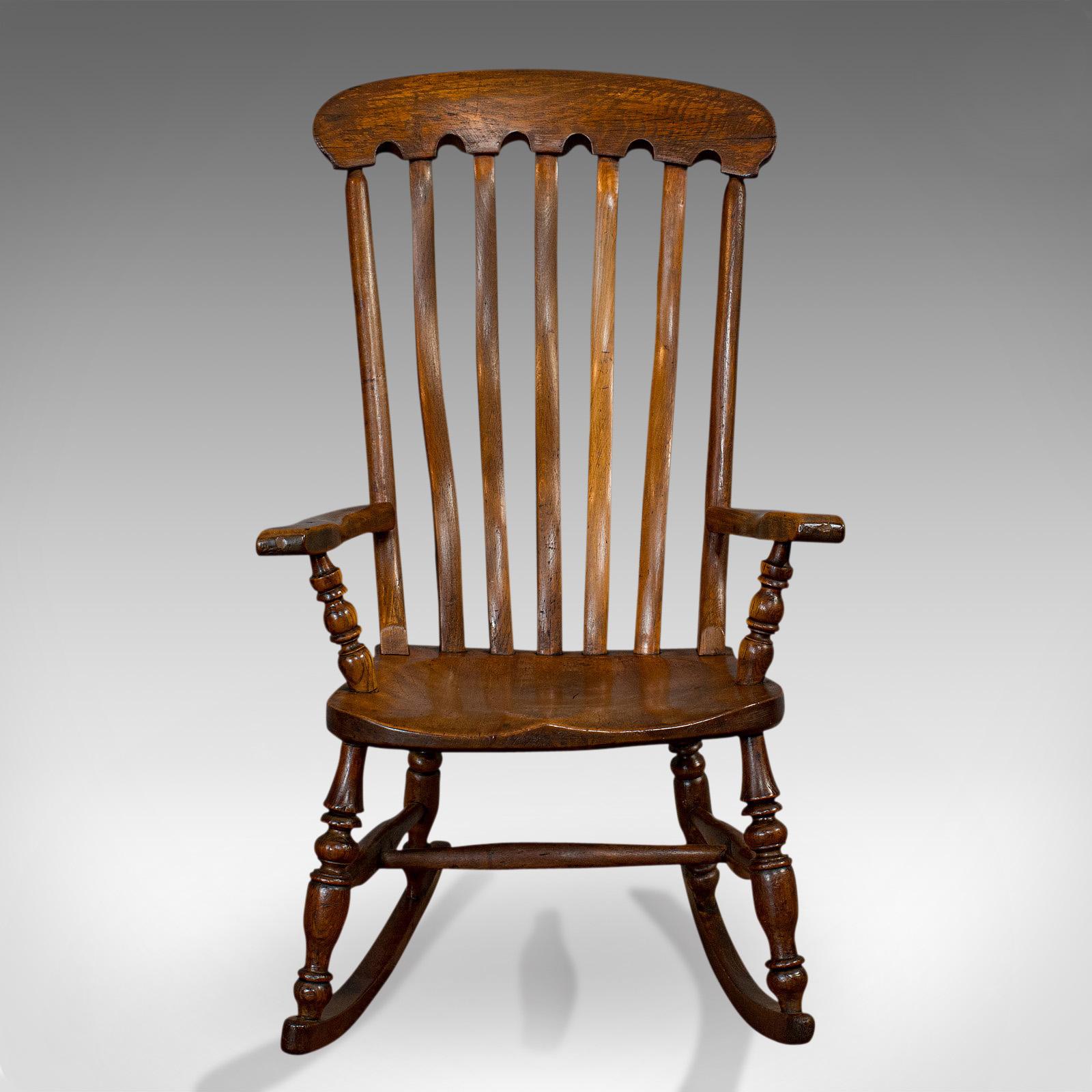 This is an antique farmhouse rocking chair. An English, elm and beech seat, dating to the Victorian period, circa 1900.

Superb rural craftsmanship
Displays a desirable aged patina
Select elm and beech shows fine grain interest
Attractive dark