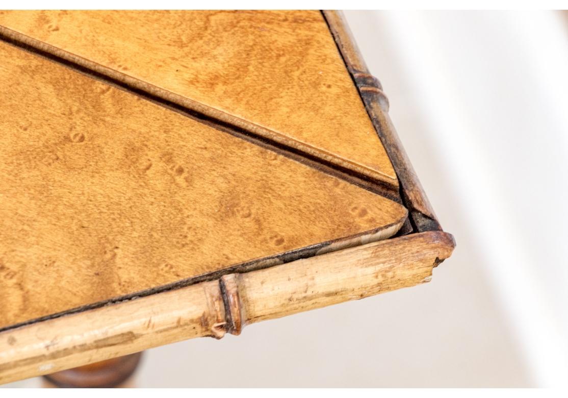  Antique  Faux bamboo and burled maple triangular drop leaf gate leg table. The burl table surface trimmed with bamboo and the top surmounted on  X form stretcher supports with vertical spindles for additional strength and resting on faux bamboo