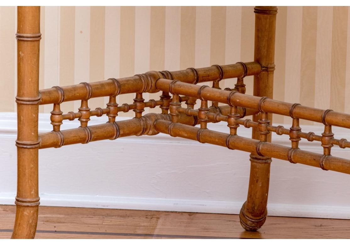 A fine Aesthetic Movement example of a charming writing desk
fashioned with elaborate galleries and simulated bamboo accents, including root feet. The desk with a single drawer with replaced turned pulls, an H-form stretcher support and faux bamboo