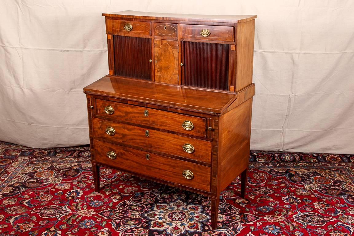 Antique federal drop front tambour desk, 19th century, mahogany and burled wood drawer fronts with string inlays. The top frame with two short drawers on either side of a small drawer with escutcheon (lacking a key). The mahogany tambour doors