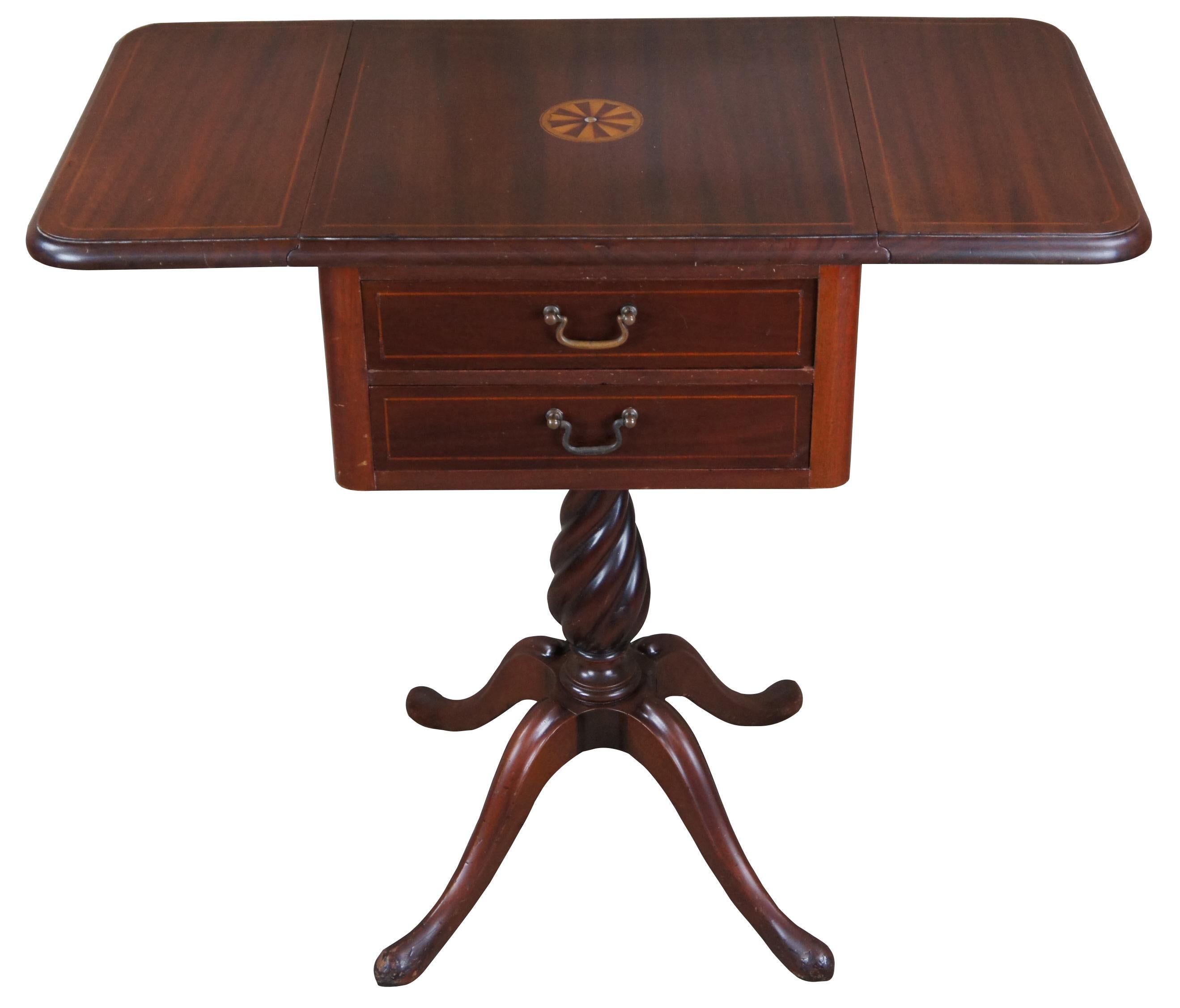 Antique pembroke parlor side accent table. Inspired by Federal & Regency styling, circa 1st quarter 20th century. Made of mahogany featuring inlaid mother of pearl pinwheel medallion with two drop leaves, two drawers (One with Dividers) and barley