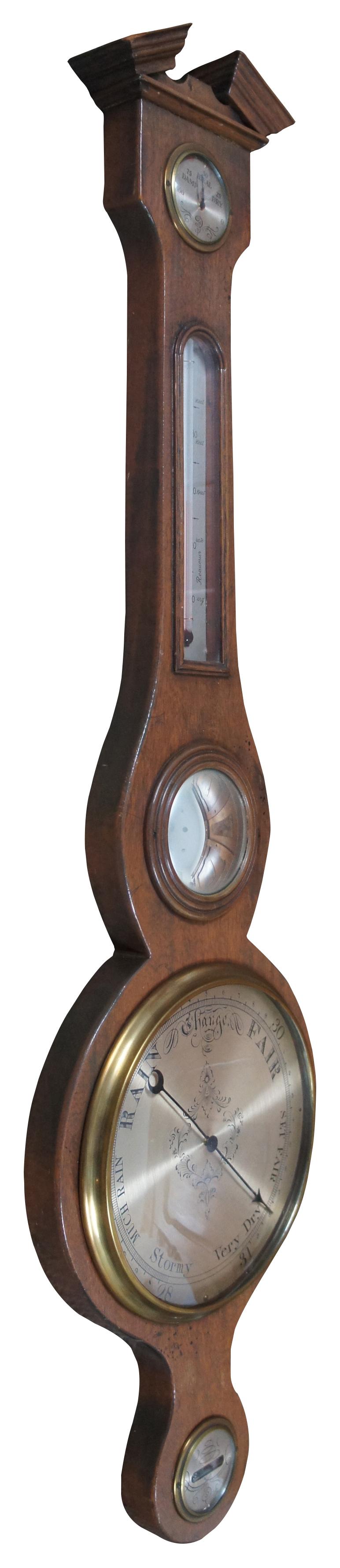 Antique banjo style wall hanging wood cased barometer and thermometer with Federal style crest and brass face. Measure: 39