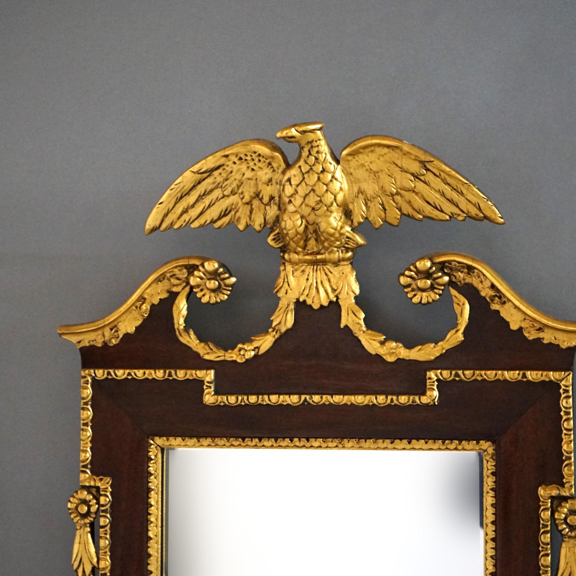 ***Ask About Reduced In-House Shipping Rates - Reliable Service & Fully Insured***
An antique Federal wall mirror offers shaped mahogany frame having giltwood figural eagle crest, flanking inverted bellflowers, and trim; en verso scripted Aug 27,