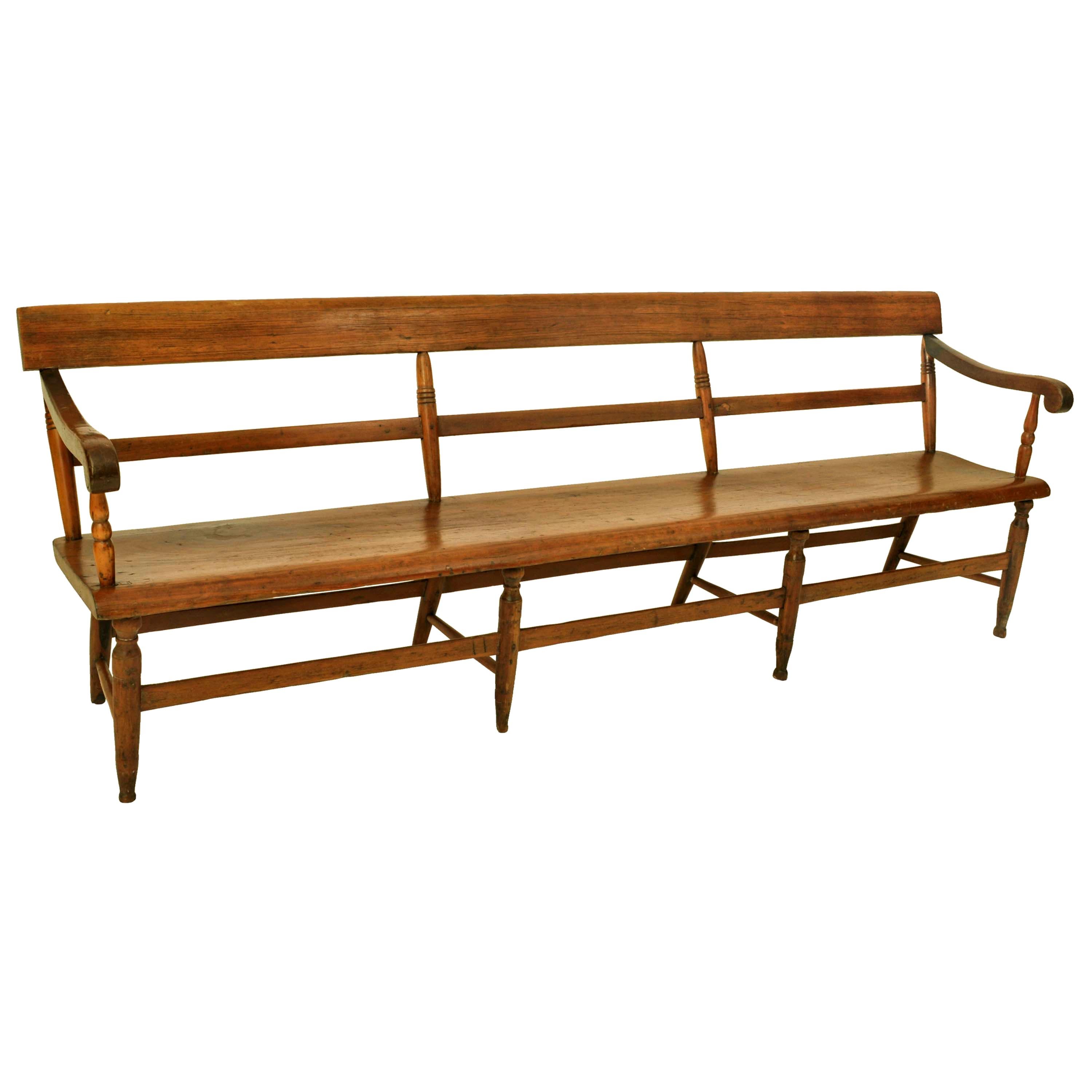 A good antique American Federal period cherry bench/settee, New England, Circa 1820.
The bench having simple turned spindles to the back and a planked backrest, the bench having scrolled arms and a shaped single plank seat. The bench is raised on