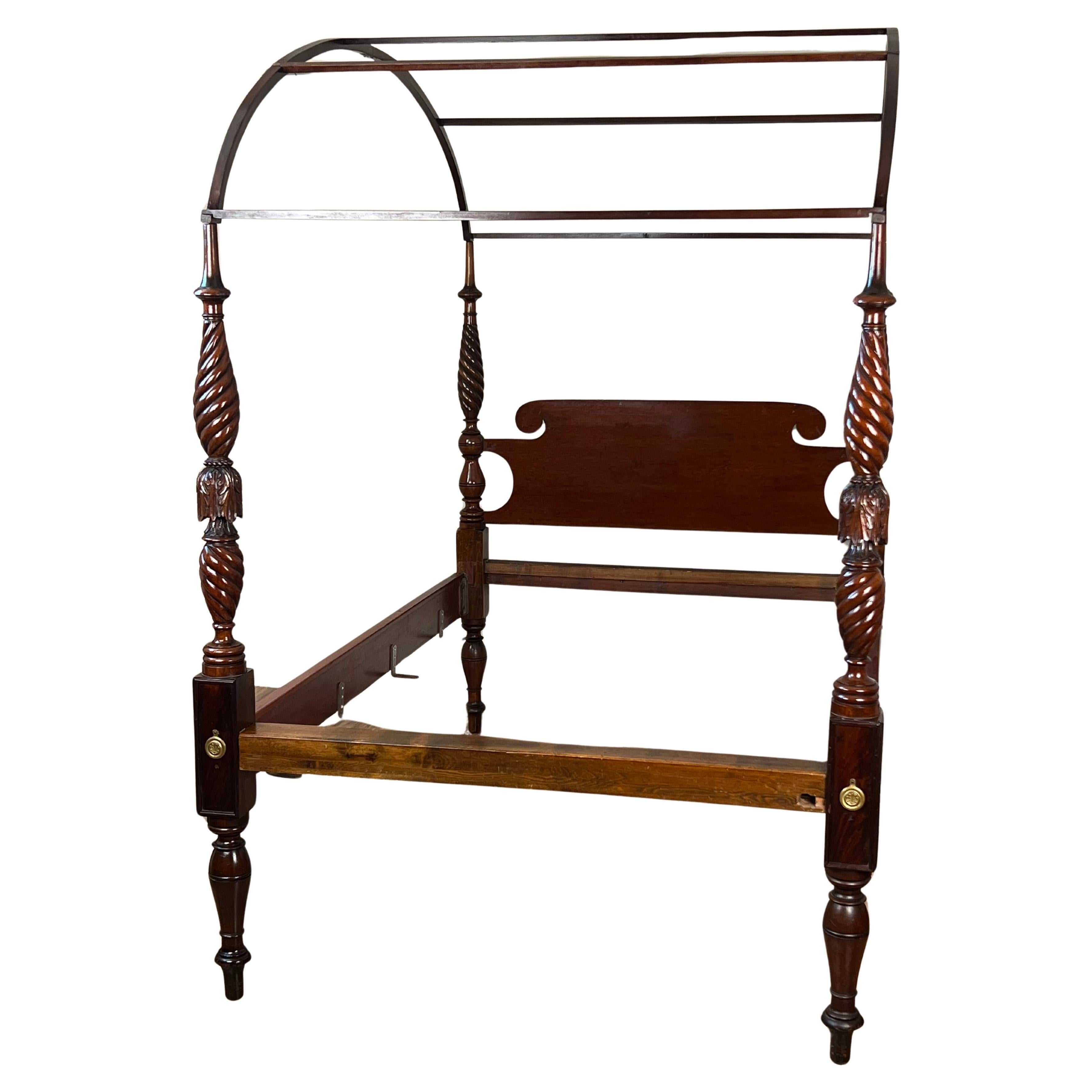 This Antique Federal Period Mahogany Full Size Canopy Bed, likely made in Massachusetts around 1820, is a refined example of early 19th-century American craftsmanship. Originally designed as a 3/4-sized bed, it was modified in the past to