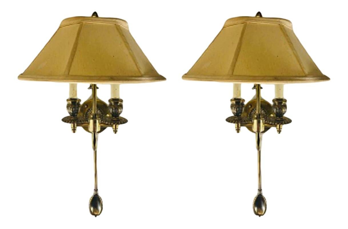 A 1970s timeless pair of Federal style cast brass wall sconces with two candelabras arms each. The sconces feature fine brass design and comes with the shades.
 
  