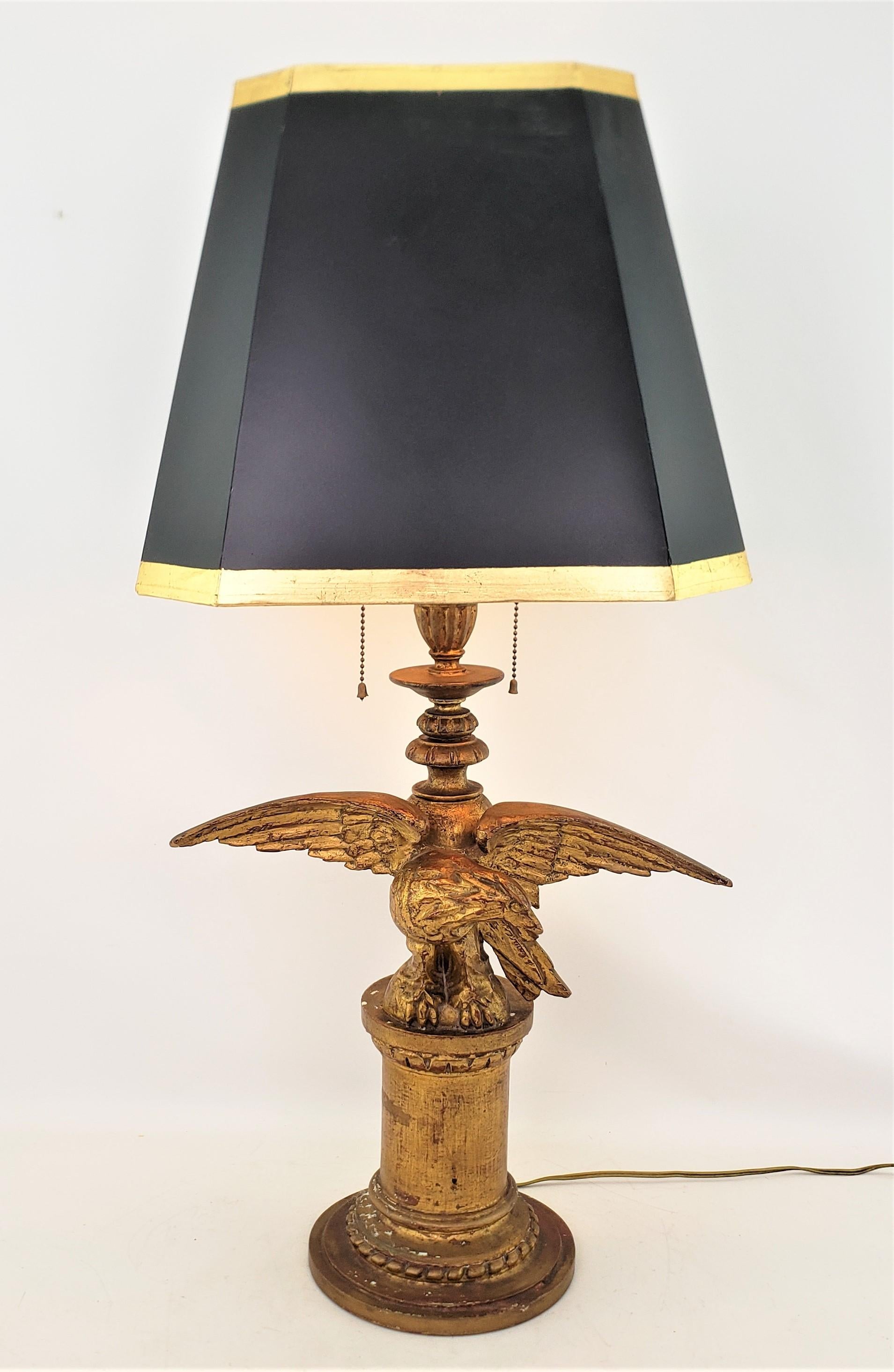 This antique well executed carved eagle table lamp is unsigned, but presumed to have originated from the United States and date to approximately 1920 and done in a Federalist style. The body of the lamp is done in a carved softwood, sealed with a