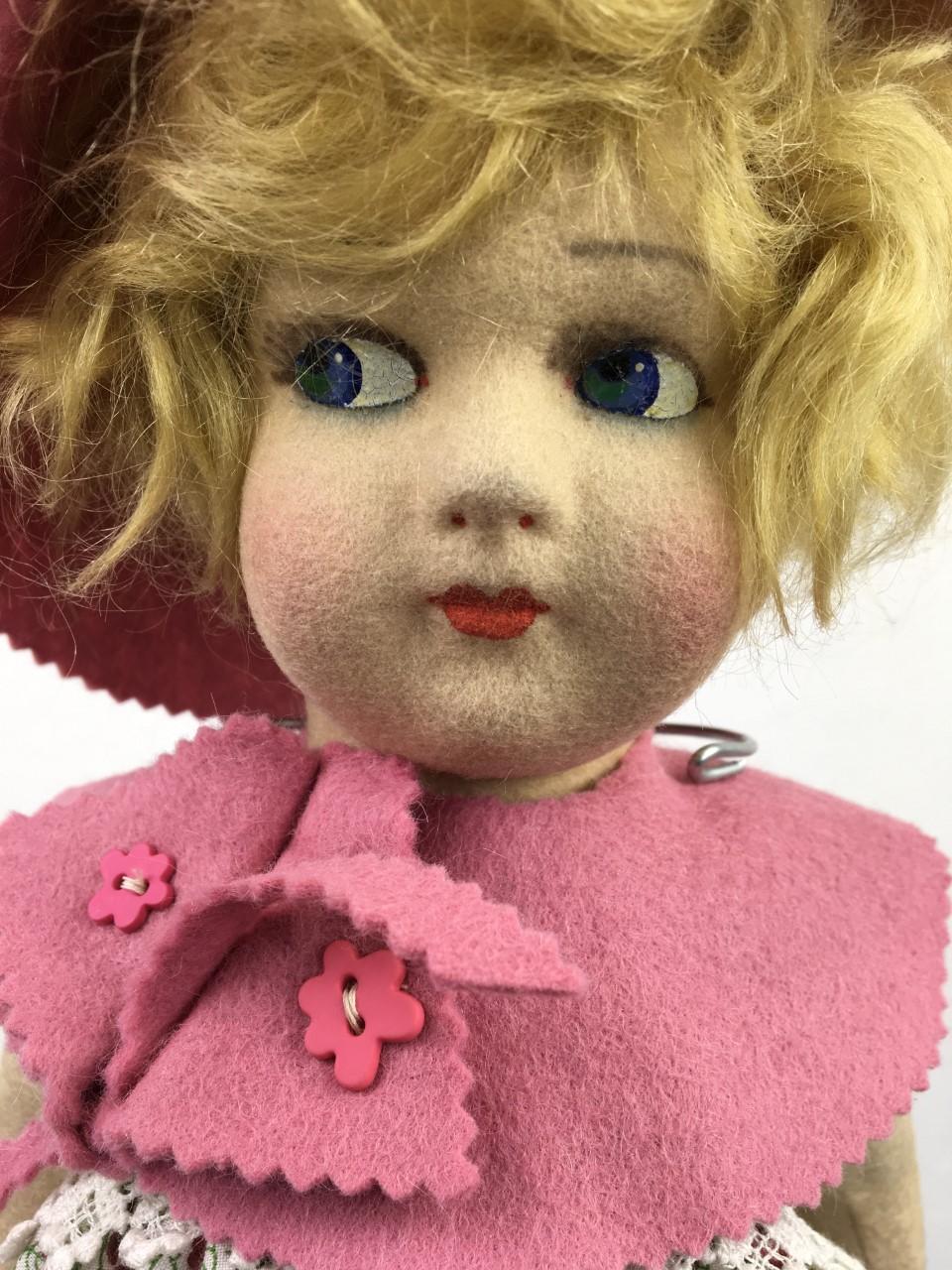 Antique felt Lenci - Lenci Style felt doll circa 1930s - 1940s.
This cute cloth doll has a pressed felt swivel head, painted eyes with a little white spot on the site, a little nose with red spots and a little red mouth which is all typical for a