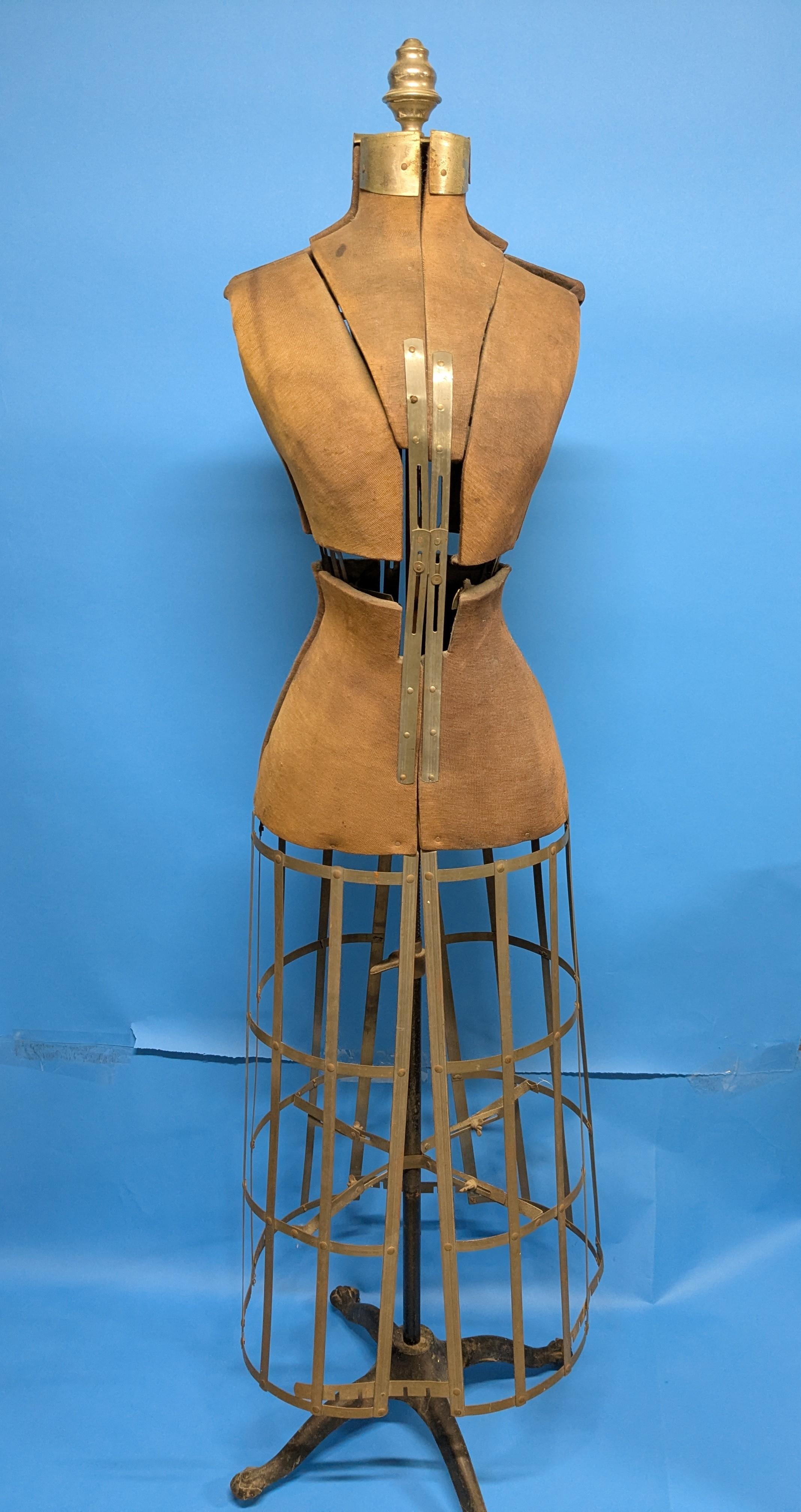 A fine antique dress form by renowned form maker Hall-Borchert.  Original finish and in working order. Fabric body with metal fixtures and cast iron cage and base on wheels. It is a lovely and functional piece of history that can display a favorite