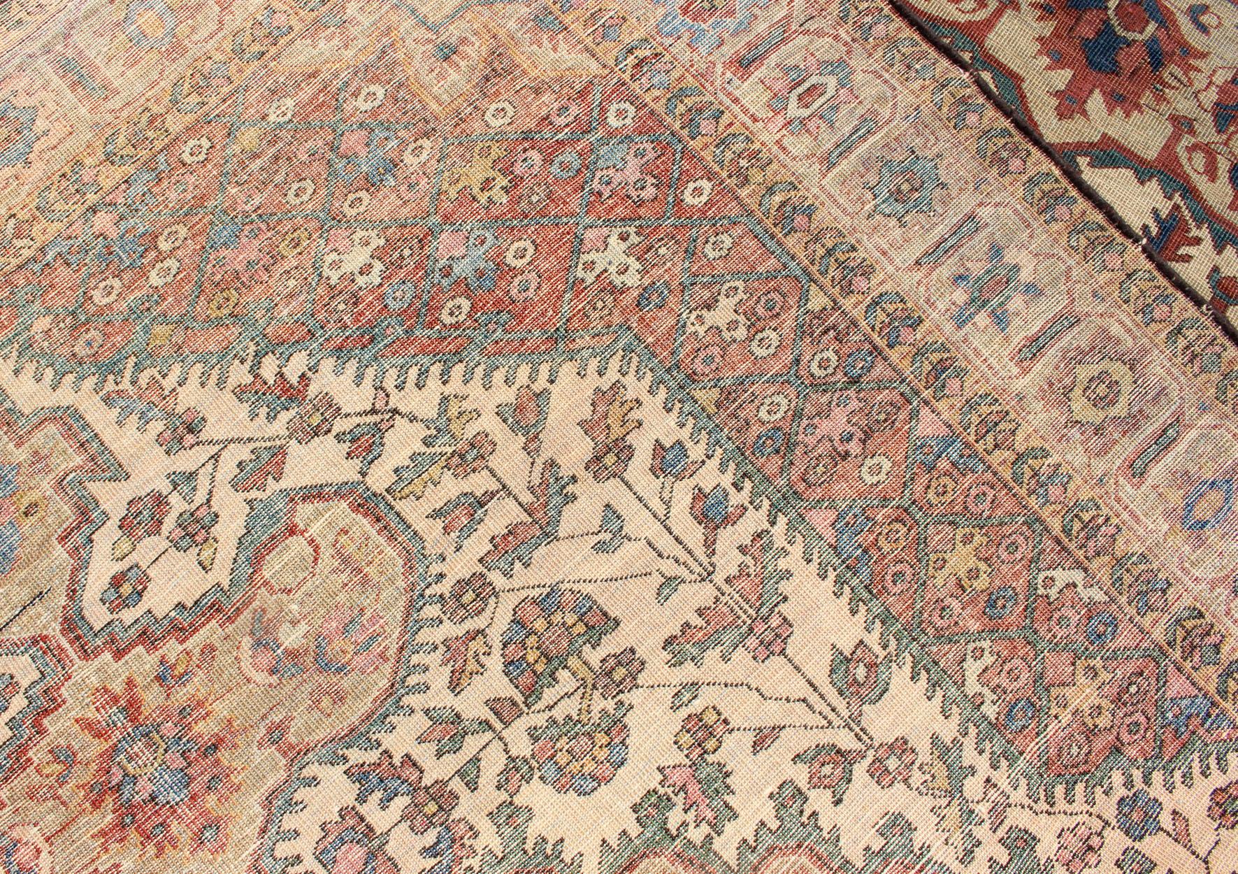 Persian Antique Feraghan Sarouk Rug in Ivory Background, Brown Red, Camel, and Teal For Sale