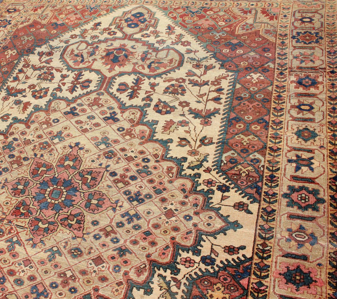 Persian Antique Feraghan Sarouk Rug in Ivory Background, Brown Red, Camel, and Teal For Sale