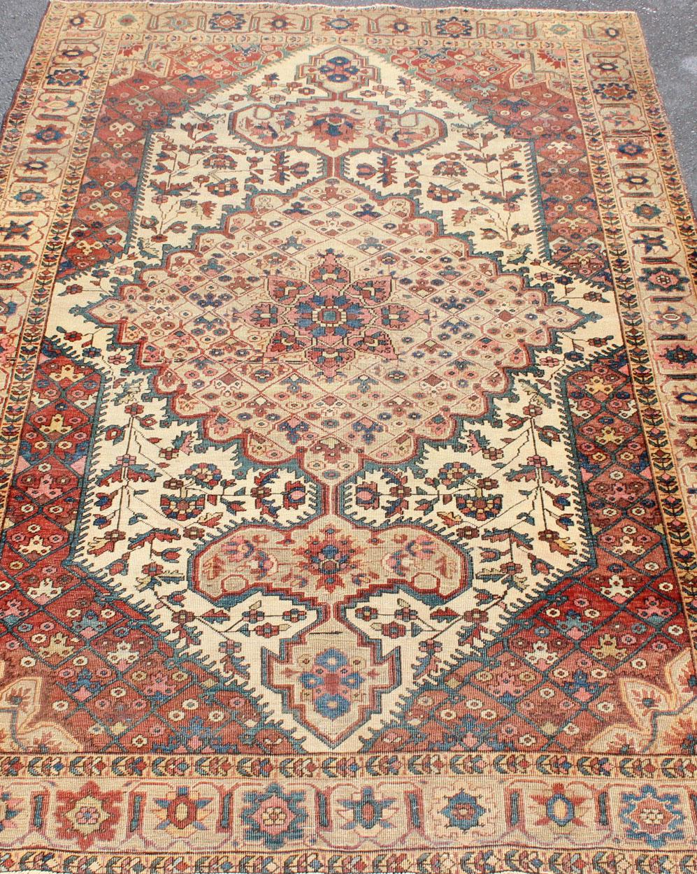 Wool Antique Feraghan Sarouk Rug in Ivory Background, Brown Red, Camel, and Teal For Sale