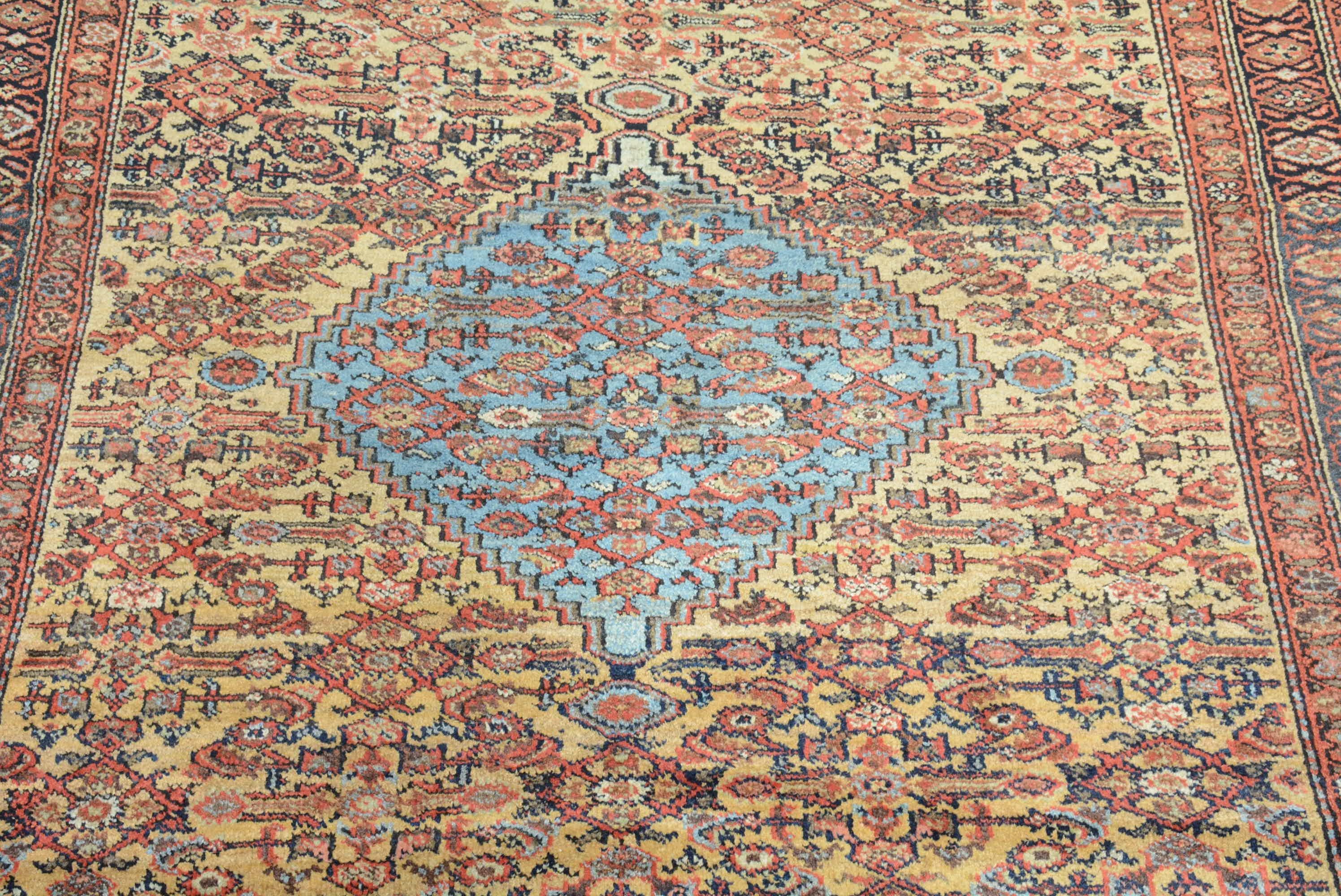 Rugs from the Fereghan district in northern Persia carefully blend geometric influences from neighboring western tribes with a more refined curvilinear aesthetic as seen in this example.