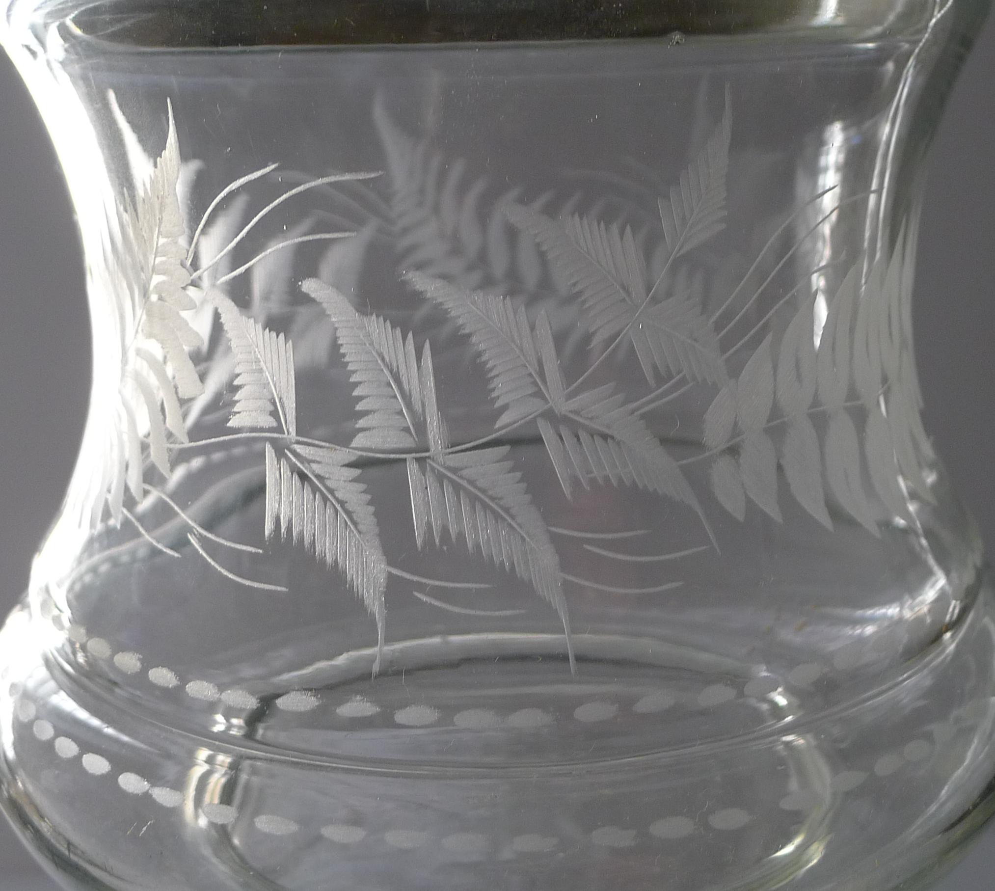 A delightful late Victorian biscuit barrel or box dating to around 1890. The glass is a lovely and unusual shape and beautifully decorated with engraved Ferns all around, so very English and so very Victorian.

To the Victorians, ferns encapsulated