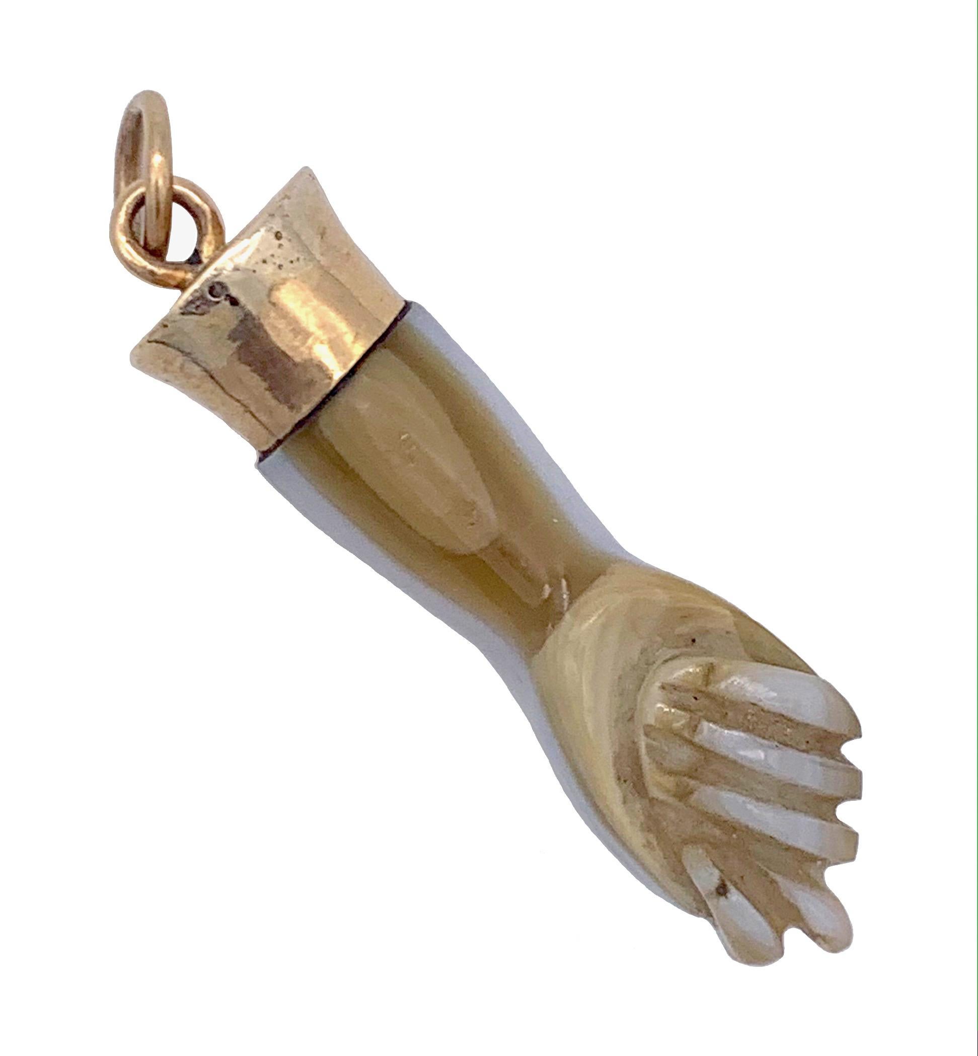 This charming sardonyx hand in the shape of fist is a so called 'figa', an amulett against the evil eye.