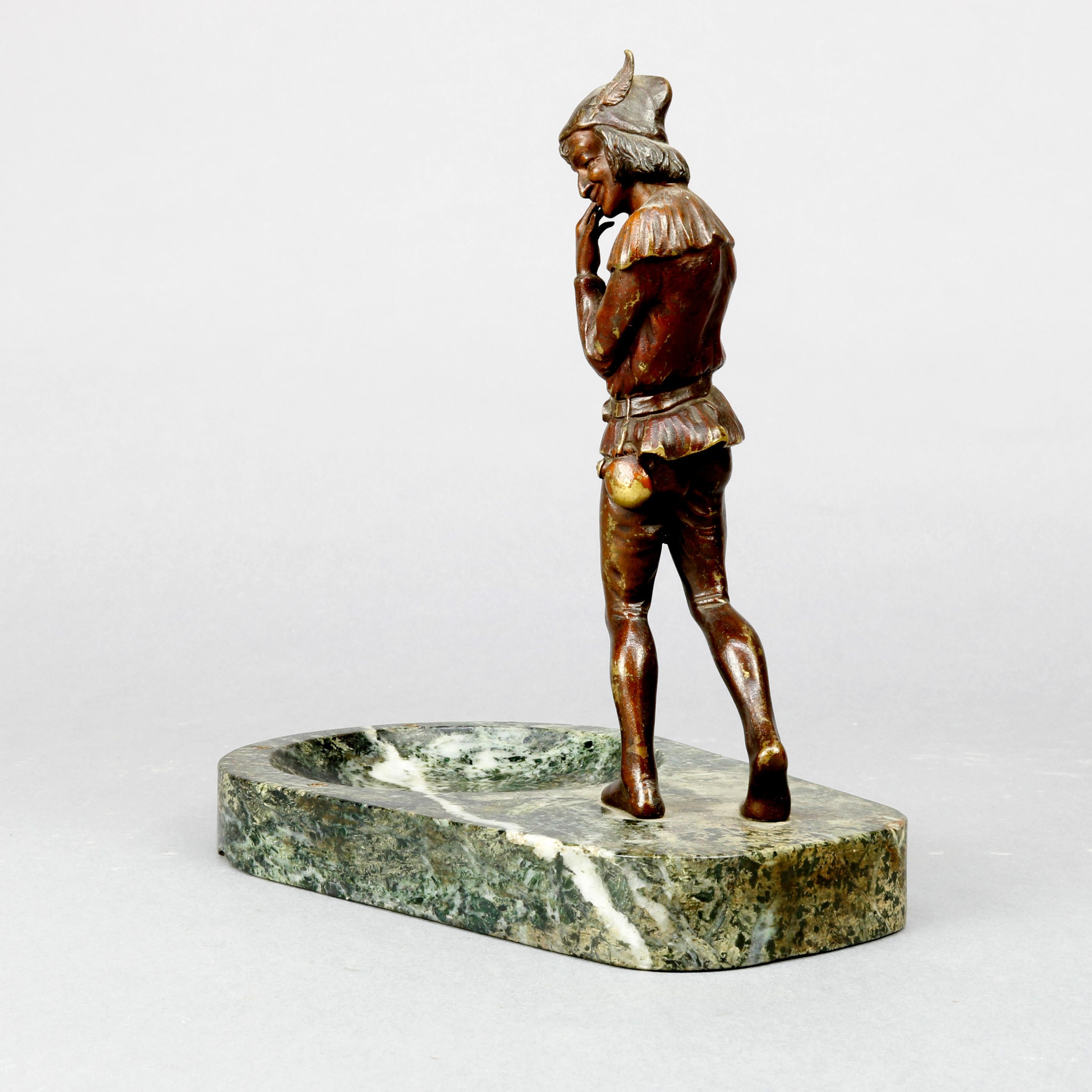 An antique figural cast bronze sculpture depicts young man in elf-like garb on marble base tray with bowl, circa 1890

Measures: 9