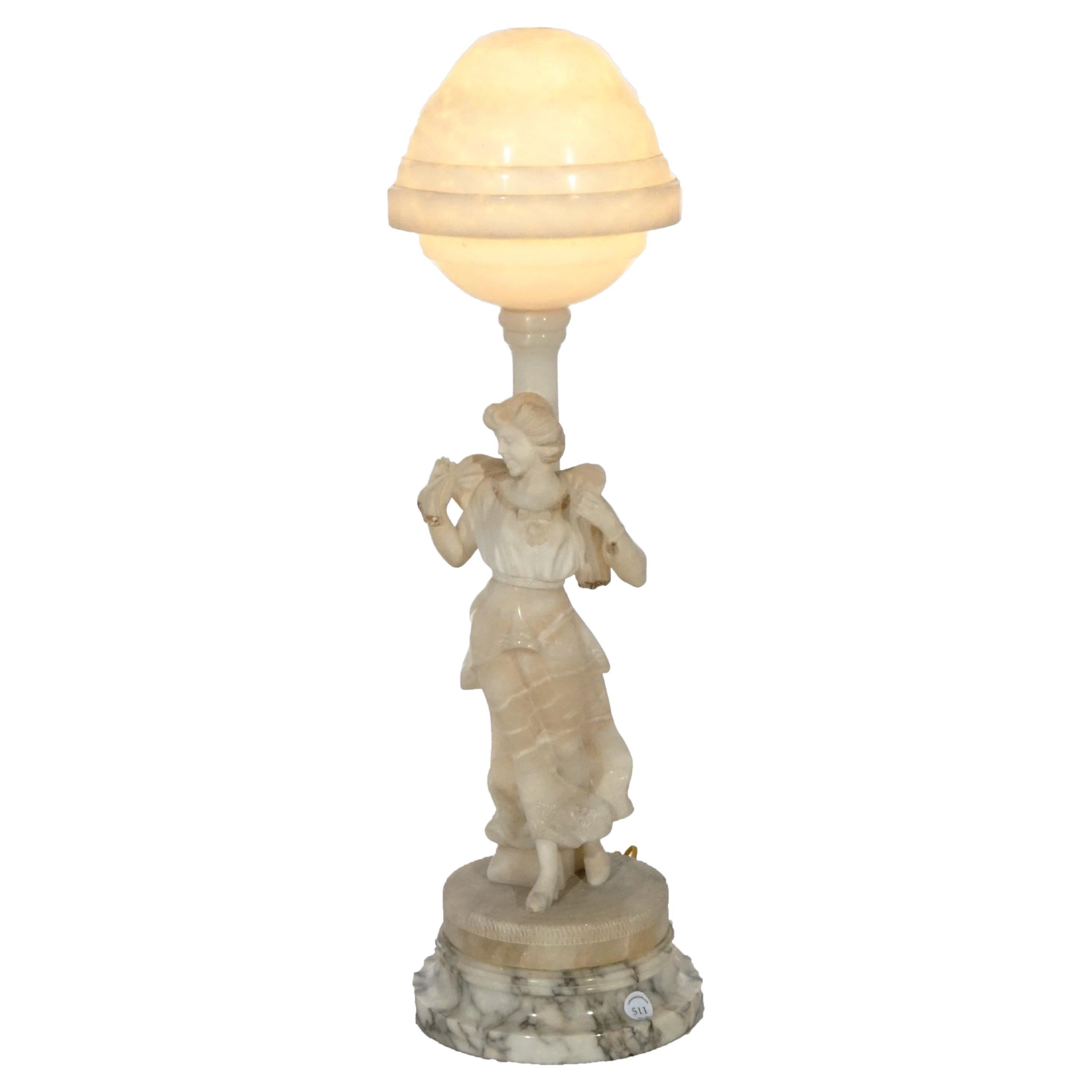 An antique figural parlor lamp offers alabaster base with carved figure of a young woman, made in Italy, re-wired for US electricity, c1900

Measures- 30.5''H x 9''W x 9''D.