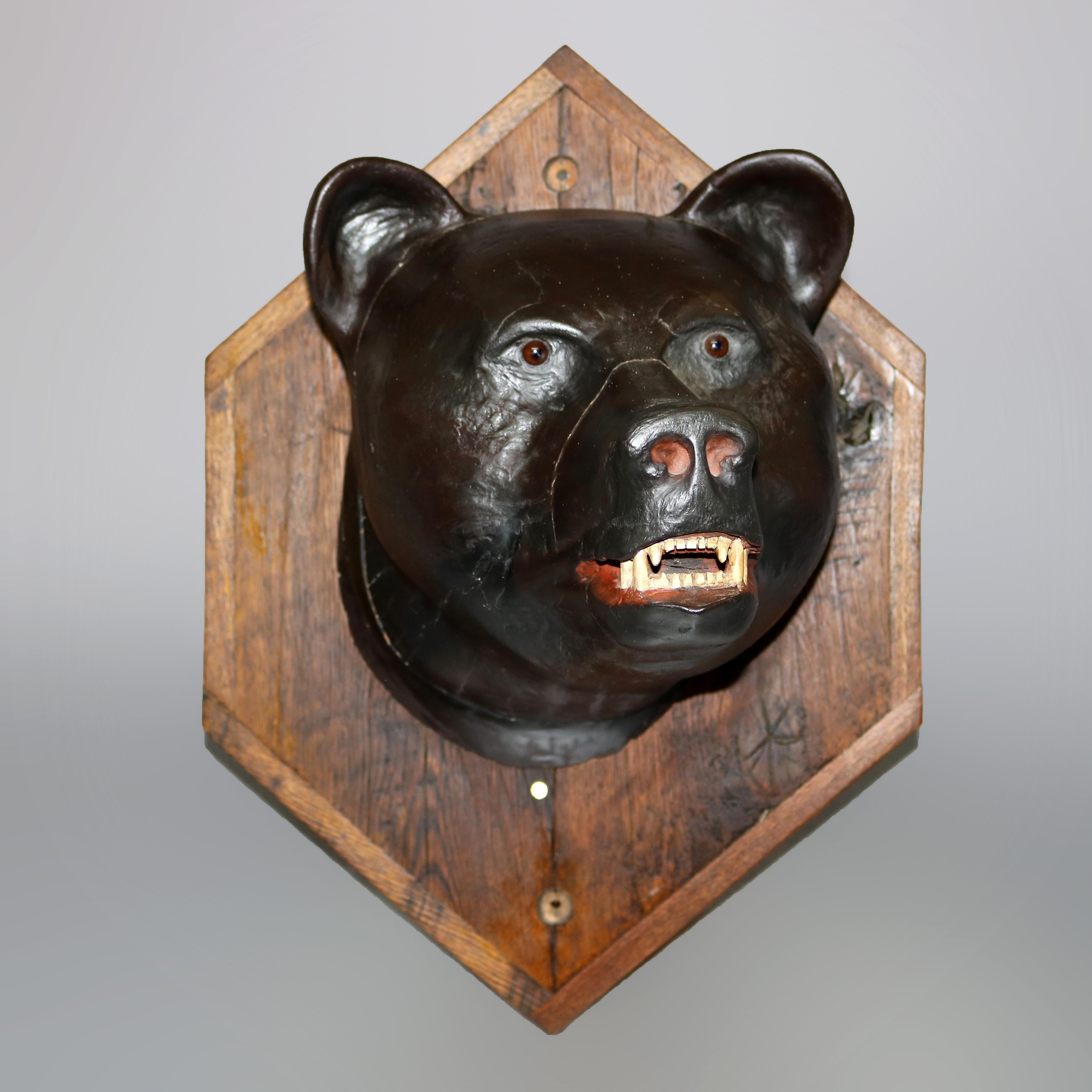 An antique figural mount offers hand carved and polychromed wood and composition bear on oak plaque, c1900

Measure: 25