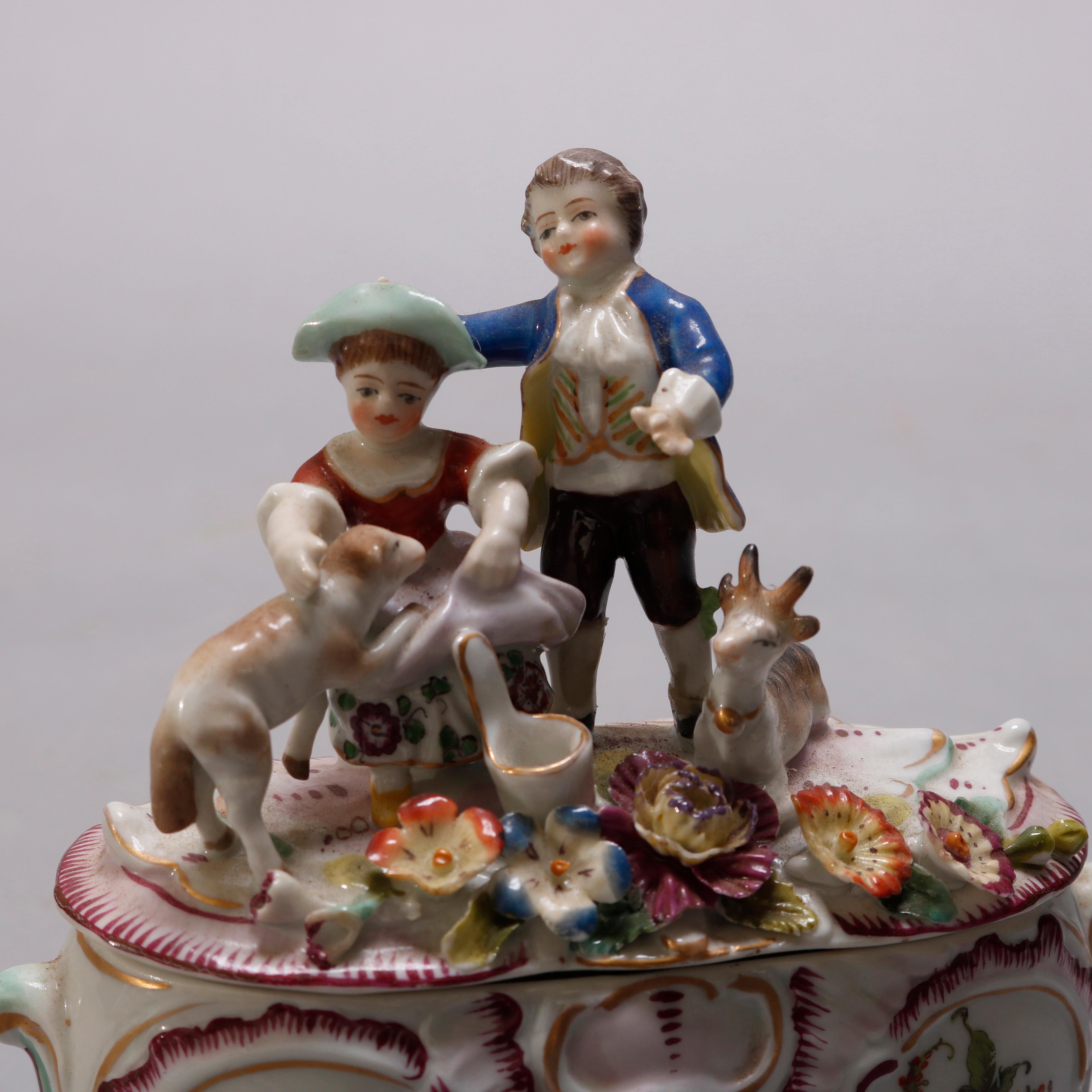 An antique Geman Meissen School figural dresser box offers hand painted porcelain with lid having figures in courting scene with boy, girl, dog and goat in countryside setting surmounting box with floral reserves and interior floral spray, gilt