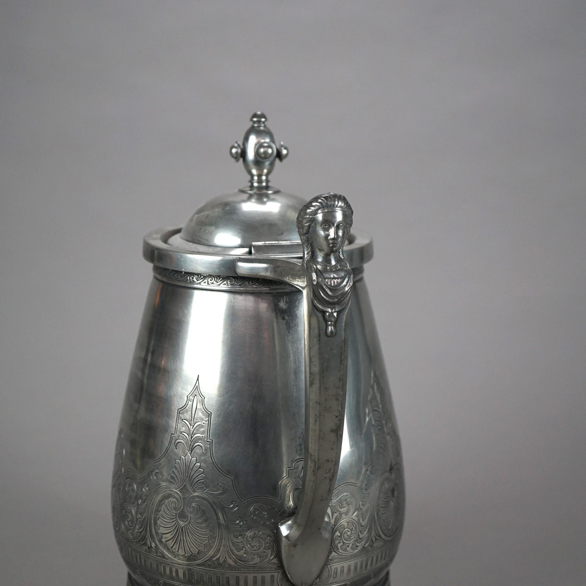 Antique Figural Silver Plated Insulated Water Pitcher with Mask and Foliate Engraving C1890

Measures - 13