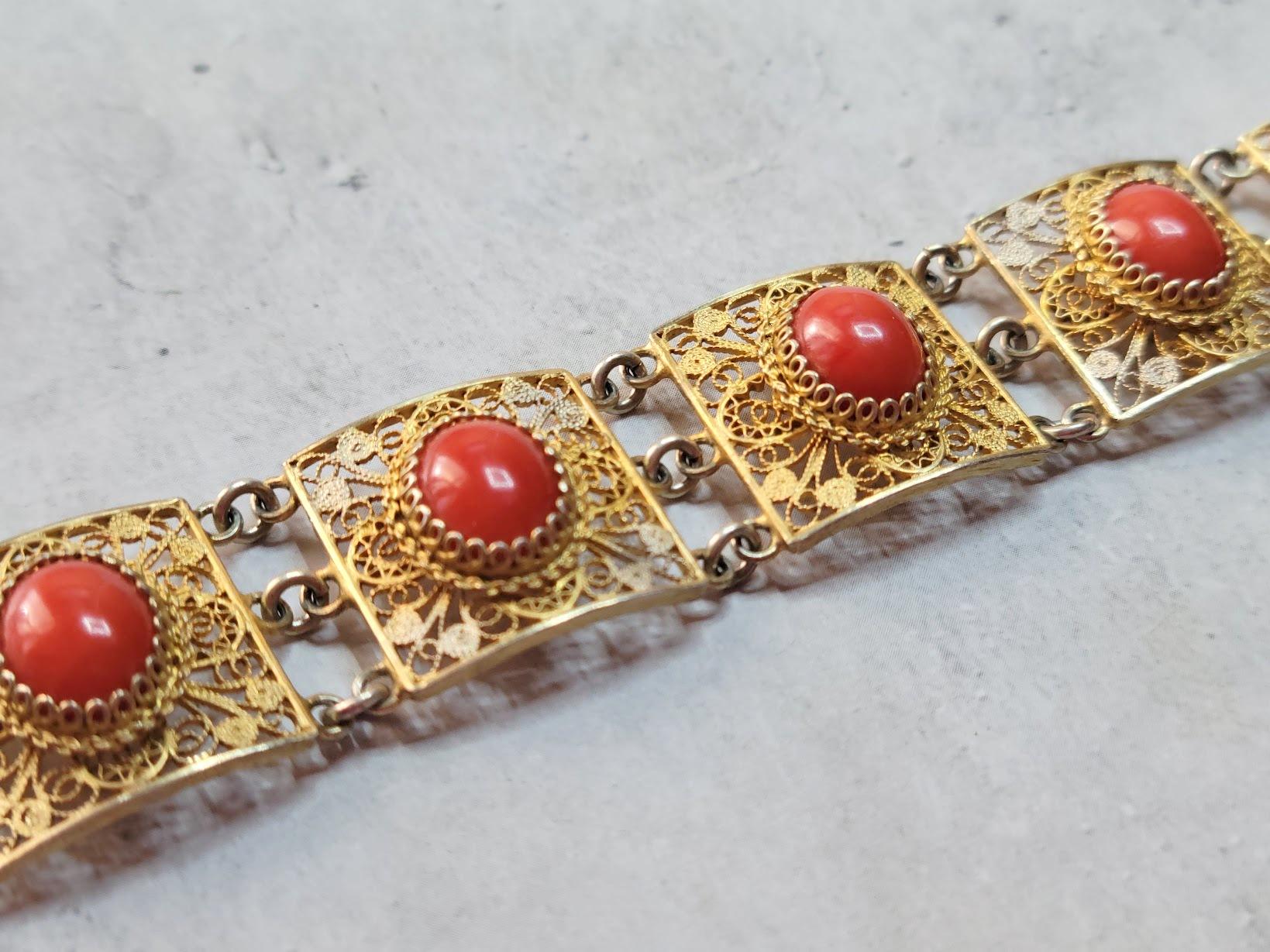 Introducing a stunning bracelet crafted from 800 silver filigree, gold-plated to perfection, adorned with four exquisite Mediterranean red coral cabochons. The 800 silver hallmark, prevalent in 19th and early 20th-century European craftsmanship,