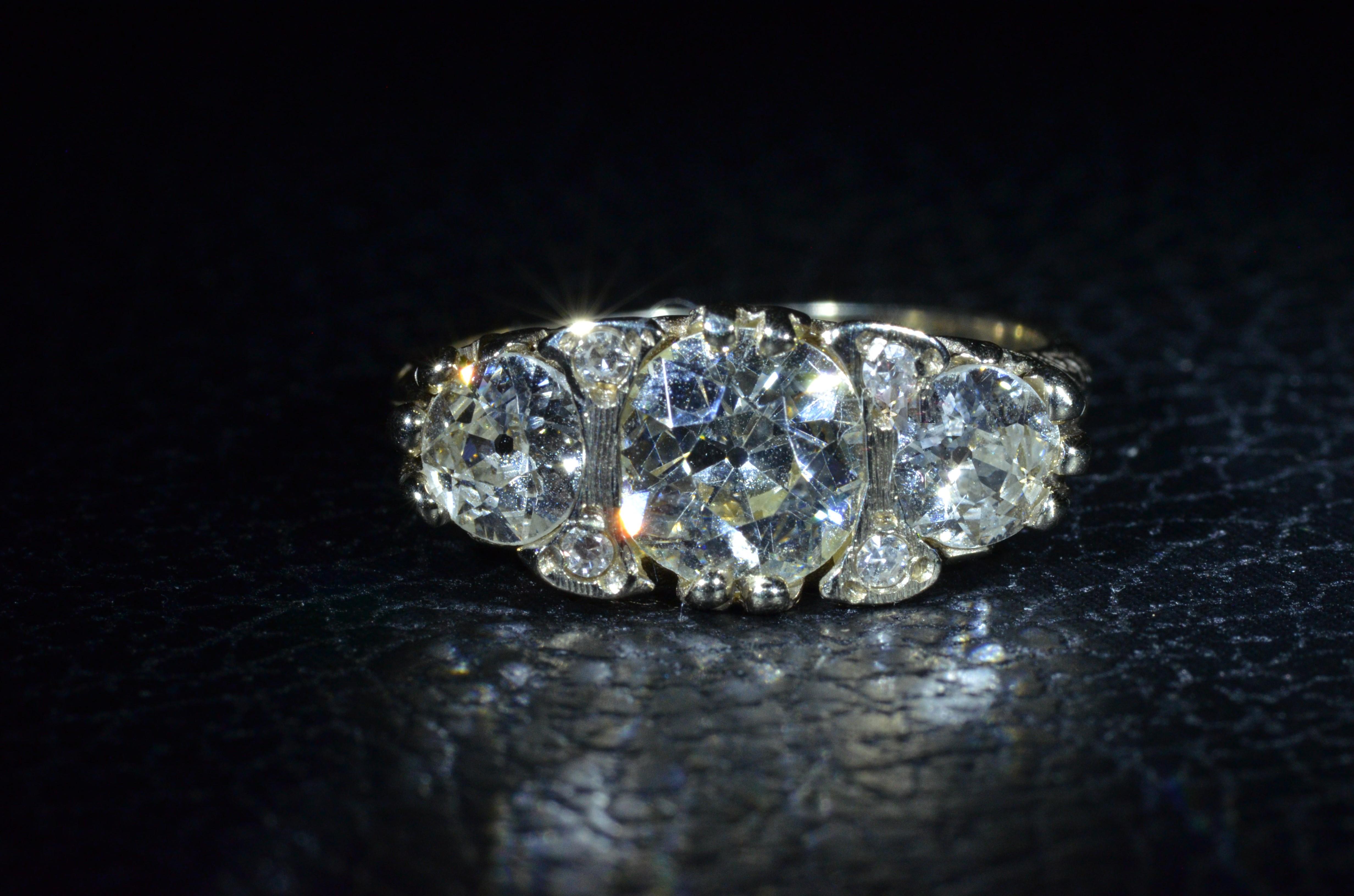 Edwardian Antique Filigree ring set with a 1.53 Carat Diamond and 0.55 Carat Each Side For Sale