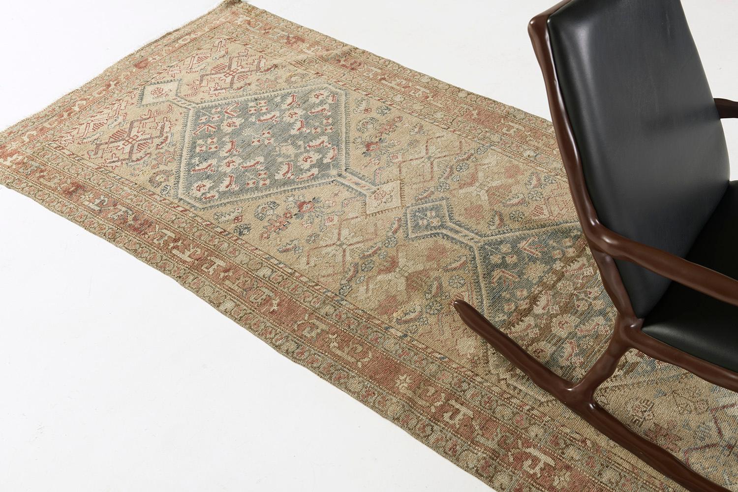 Behold and grab a glance at the charm of the Persian Malayer from our sought-after antique collection. Majestic neutral tones feature the outline details of Persian symbols with red and blue accents. Elegant medallions are aligned at the center that