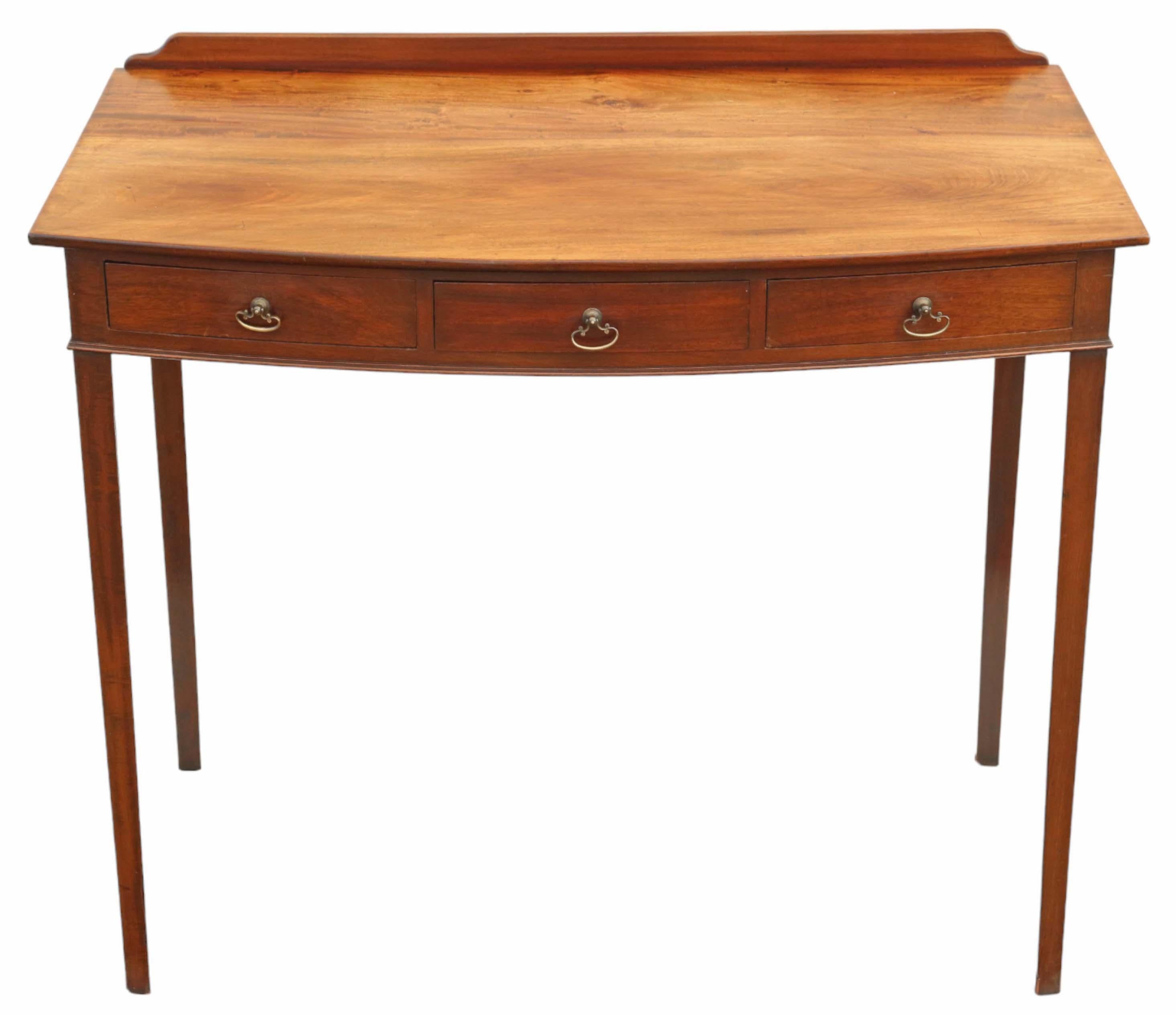 Antique, fine-quality 19th Century bow-front mahogany writing dressing table desk. Exhibiting a lovely age, color, and patina.

This piece is free from loose joints or woodworm, exuding age, character, and charm. The mahogany-lined drawers slide