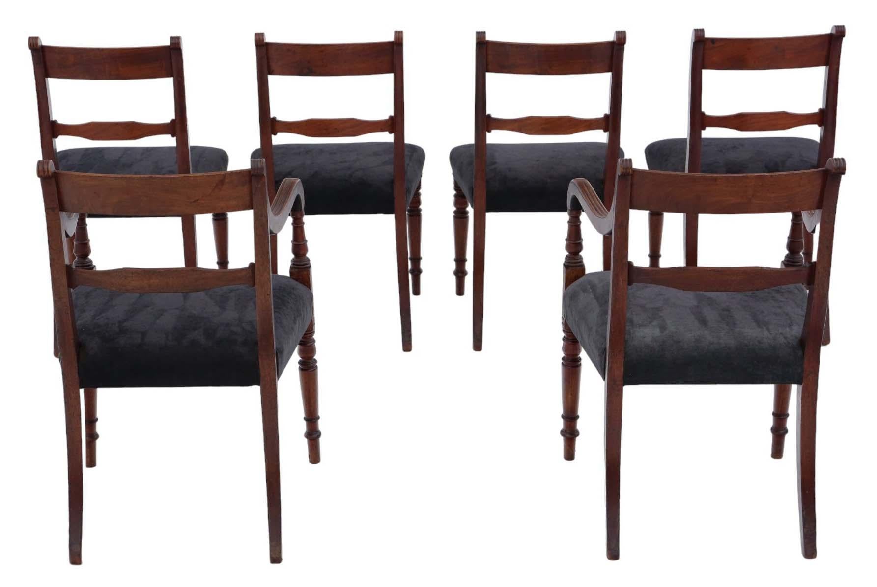 High-quality set of six (four regular and two carver) Georgian circa 1810 mahogany dining chairs, boasting an antique charm.

Robust construction with sturdy joints and free from woodworm damage.

Recently upholstered in elegant black velour,