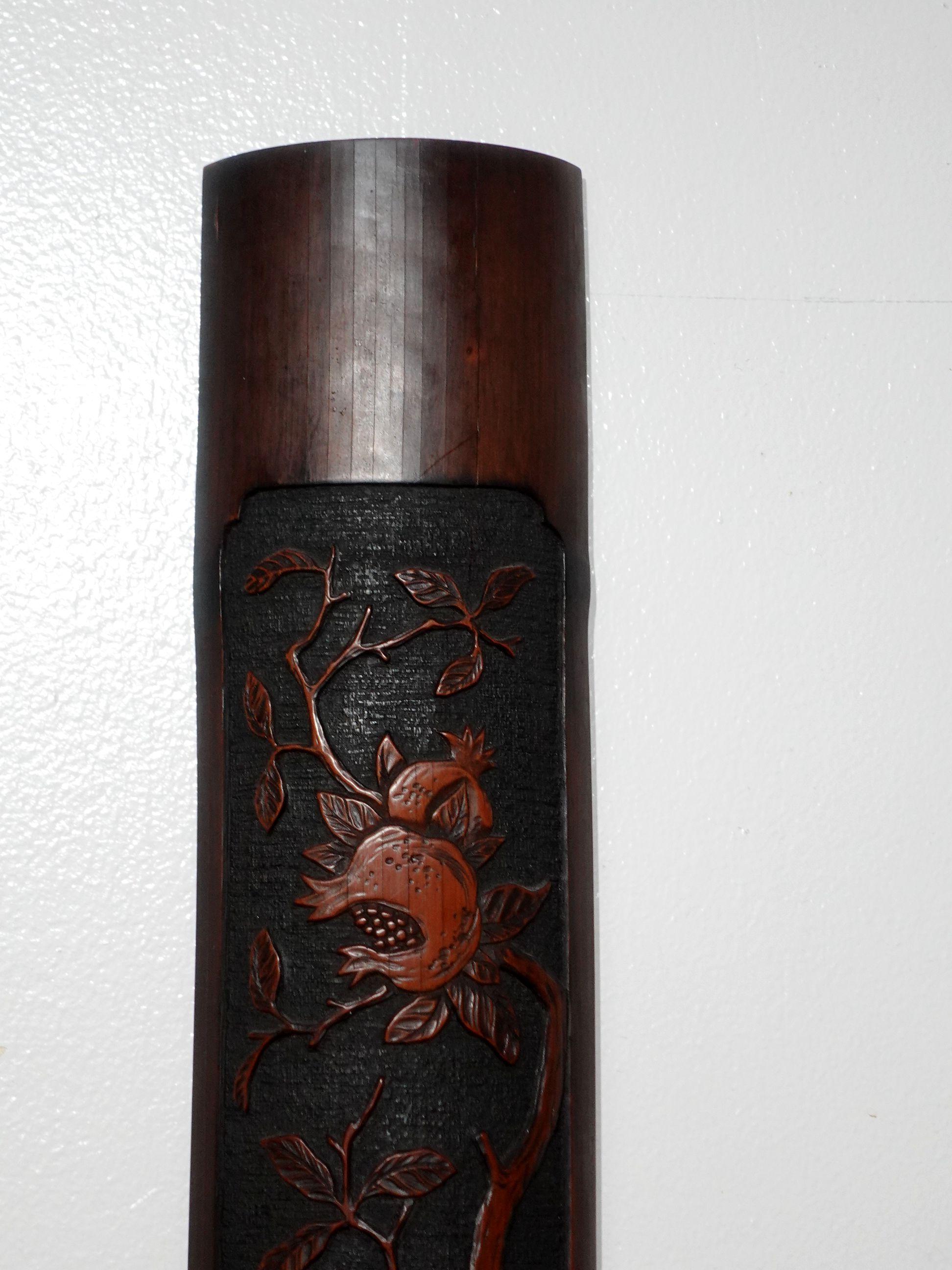 A finely Japanese Bamboo carving, early 20th century, a long rectangular convex panel carved with ripe pomegranates and a bird on a branch, lg. 36 in.
   