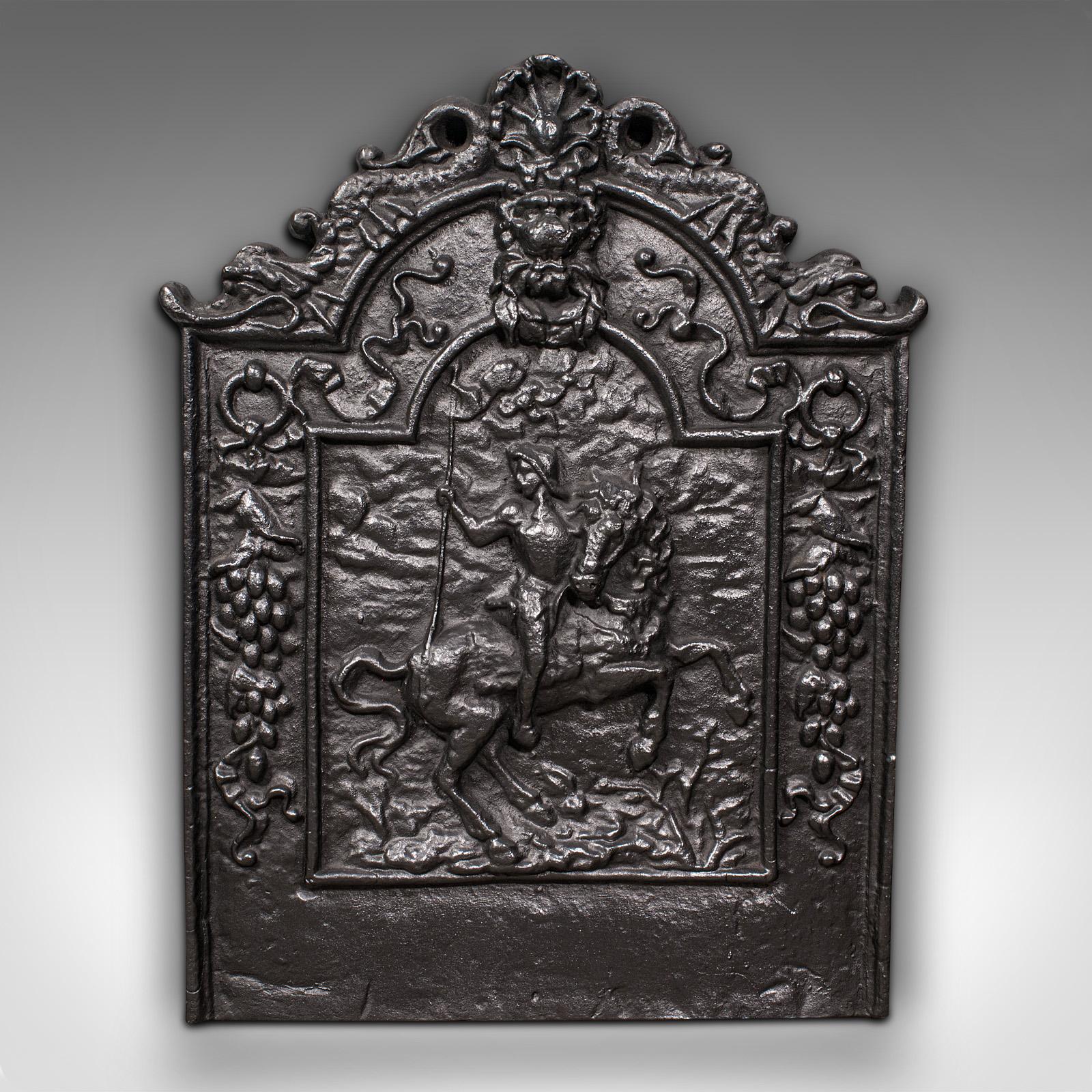 This is an antique fire back. An English, cast iron decorative fireplace back, dating to the Victorian period, circa 1900.

Charmingly ornate cast fire back with superb relief detail
Displays a desirable aged patina and in good order
Graphite
