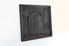 Antique fireback from cast iron from the early 18th century