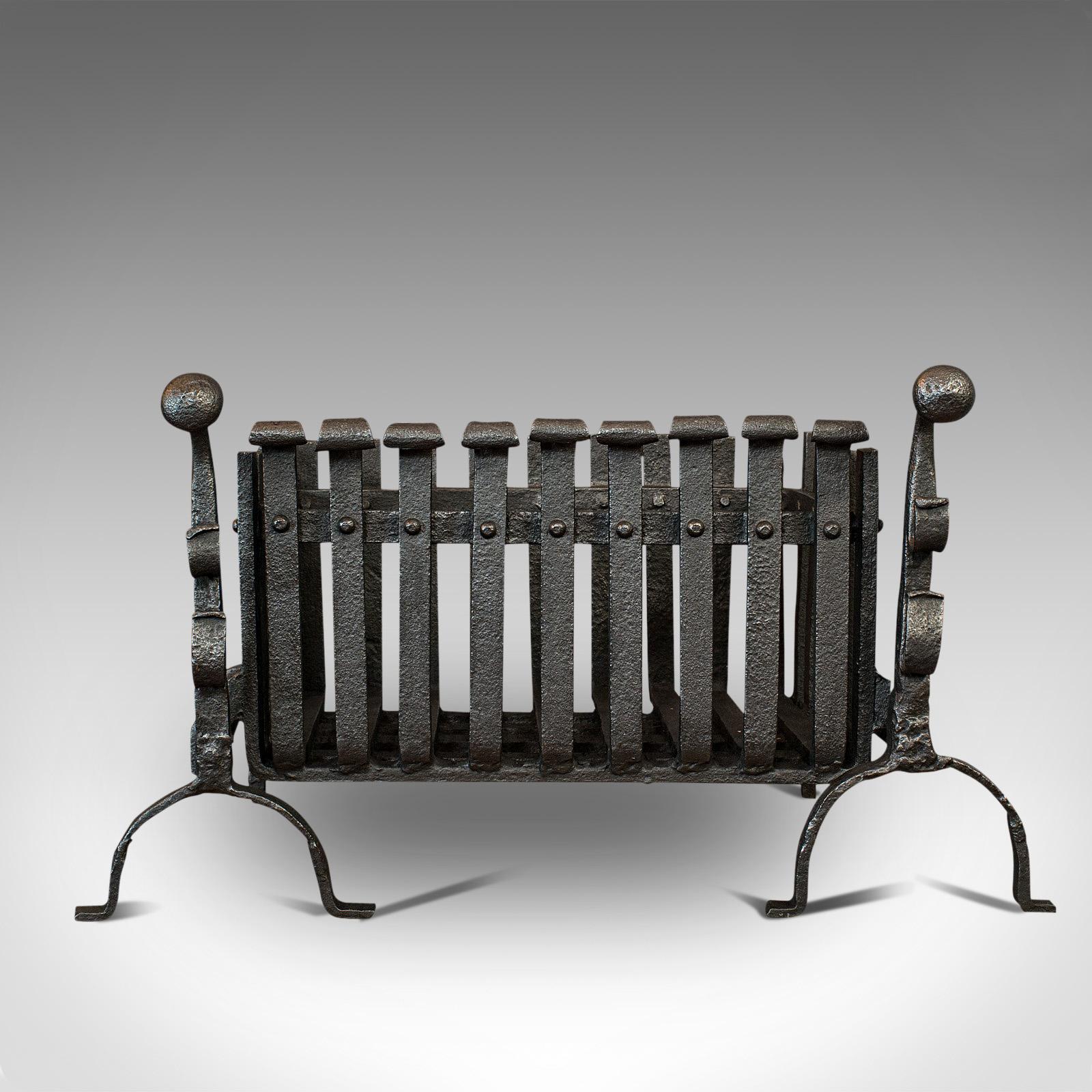 This is an antique fire basket with andirons. An English, cast iron fireside set with grate and fire dogs, dating to the Victorian period, circa 1900.

Furnish the hearth with Victorian appeal
Displaying a desirable aged patina
Cast and wrought