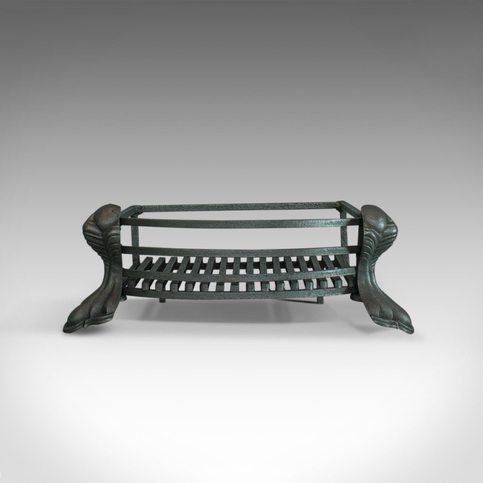 This is an antique fire basket. An English, iron, fireplace grate dating to the late 19th century, circa 1900.

Freestanding basket of quality craftsmanship
hand forged iron displays a desirable aged patina
finished in traditional