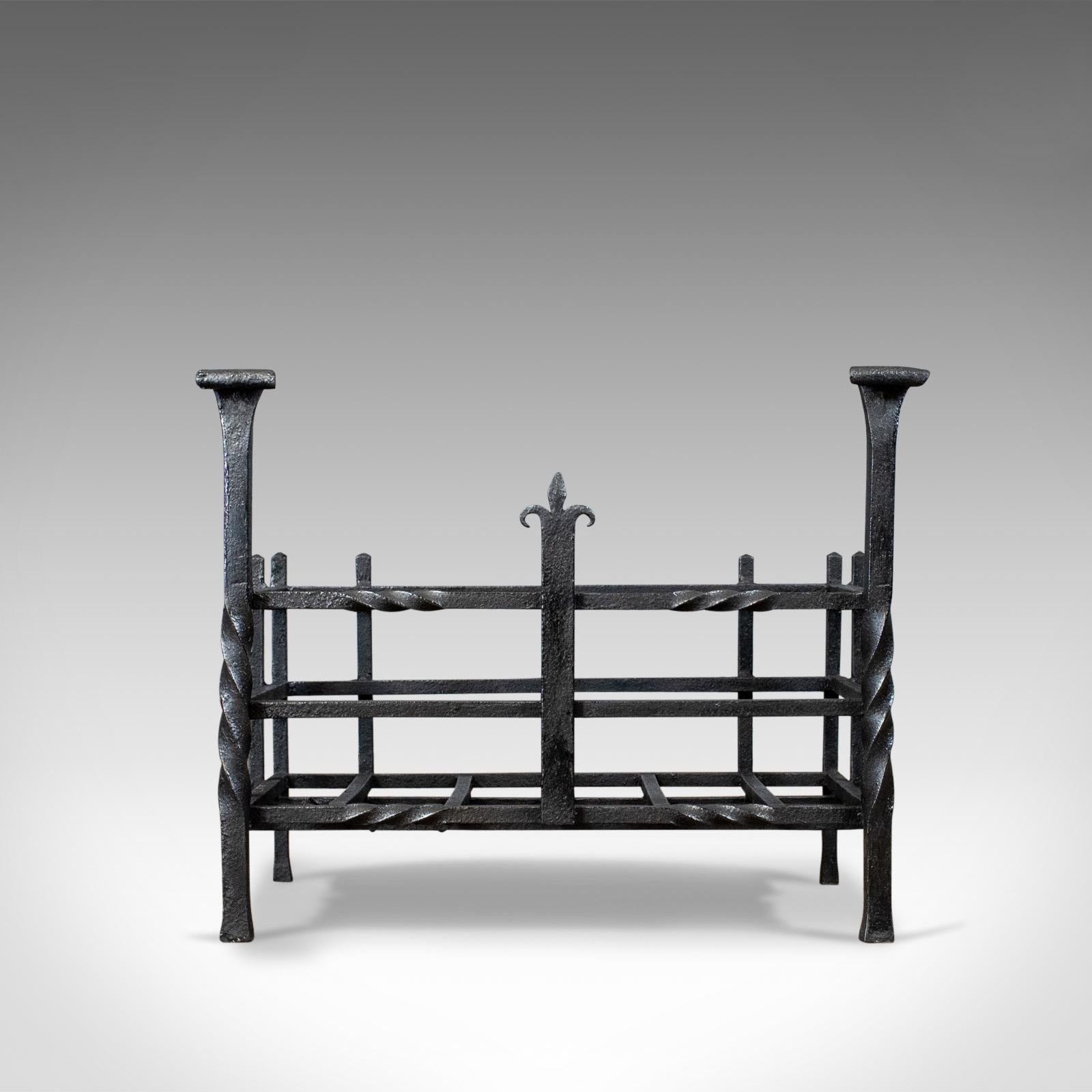 This is an antique fire basket in the Gothic taste, an English, free-standing, forged iron fireplace grate dating to the late Victorian period, circa 1900.

Attractive styling offering a generous basket 
Suitable for all fuel types
Bar twist