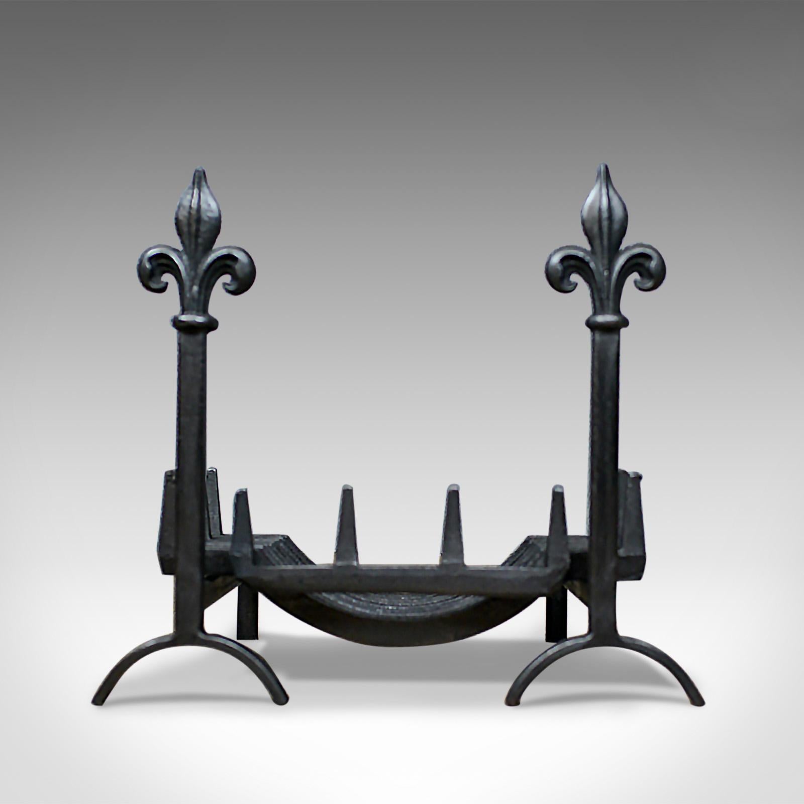 This is an antique fire basket, or grate, on dogs, or andirons, an English, Victorian fireplace accessory dating to the early 20th century, circa 1900.

A quality grate and dogs in attractive hand forged and cast iron
Standing on arched andirons